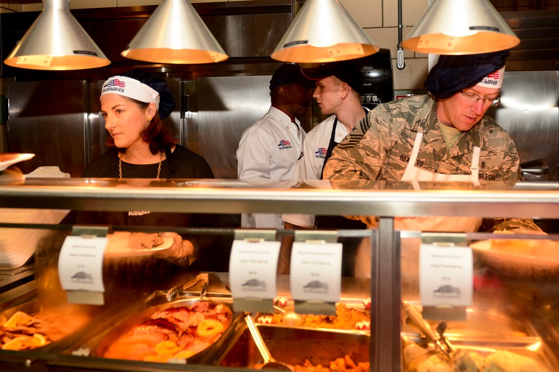 U.S. Air Force Chief Master Sgt. Ronald Beadles, the command chief of the 1st Fighter Wing, serves a Thanksgiving meal at Langley Air Force Base, Va., Nov. 26, 2015. Beadles joined fellow Langley leadership to serve a traditional holiday meal to Service members and their families. (U.S. Air Force photo by Airman 1st Class Derek Seifert)