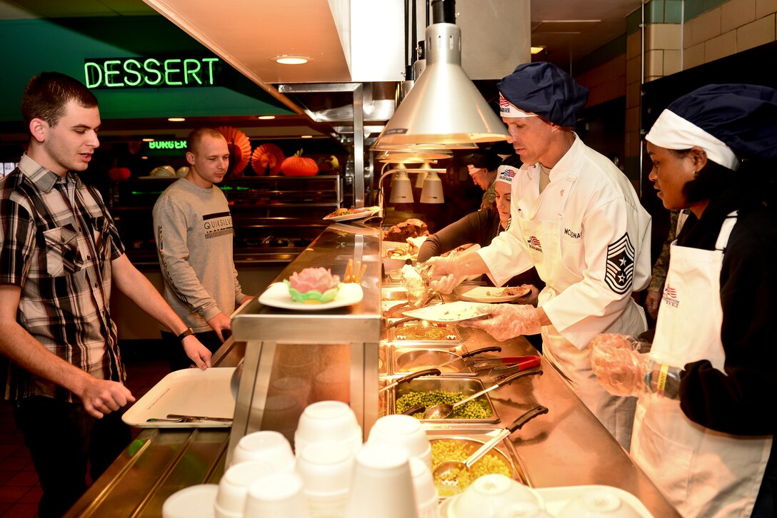 U.S. Air Force Chief Master Sgt. Steve McDonald, the command chief of Air Combat Command, serves a Thanksgiving meal to Airmen at Langley Air Force Base, Va., Nov. 26, 2015. The meal was served to help Service members who could not go home during the holiday. Langley leadership served them a traditional Thanksgiving meal including turkey, ham and mashed potatoes with gravy. (U.S. Air Force photo by Airman 1st Class Derek Seifert)