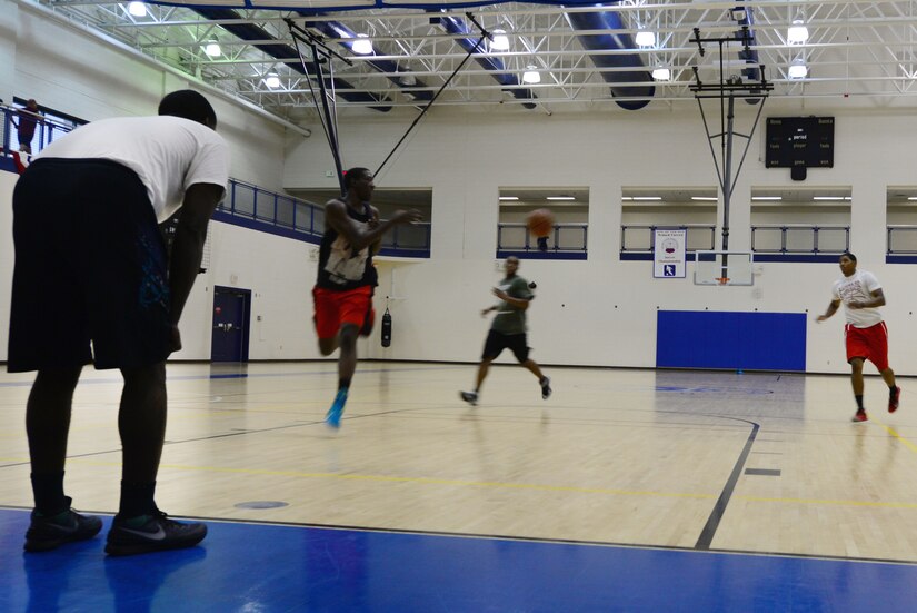 U.S. Service members run a three-man weave cardio drill during a Joint Base Langley-Eustis (JBLE) varsity basketball team practice at Langley Air Force Base, Va., Sept. 22, 2015. The team is comprised of 11 U.S. Airmen and six U.S. Soldiers. (U.S. Air Force photo by Airman 1st Class Derek Seifert)