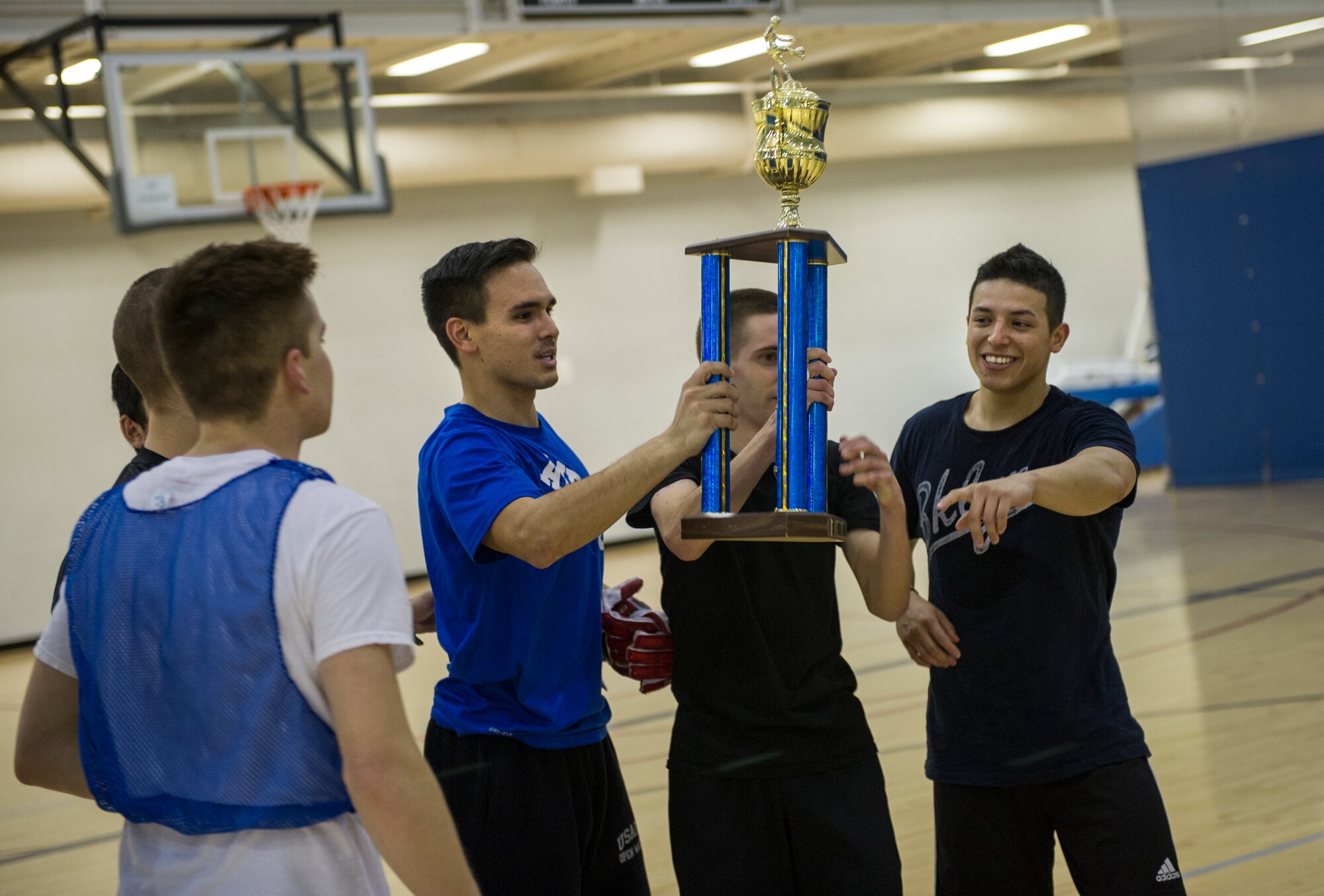 The 5th Contracting Squadron team celebrates their victory after the intramural indoor soccer championship at Minot Air Force Base, N.D., Nov. 24, 2015. After coming down to penalty kicks, 5th CONS beat the 5th Medical Group team. (U.S. Air Force photo/Senior Airman Apryl Hall)