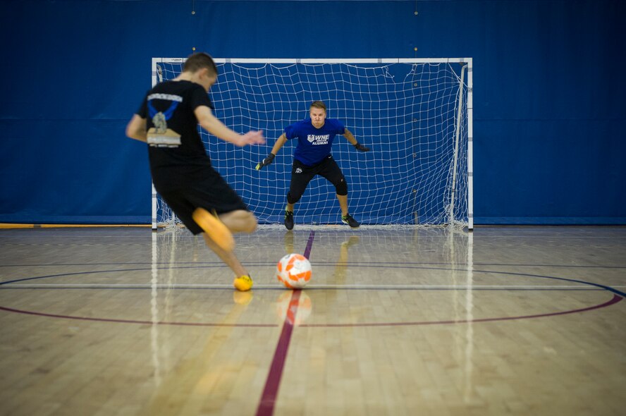 An Airman from the 5th Contracting Squadron takes a penalty kick during the intramural indoor soccer championship at Minot Air Force Base, N.D., Nov. 24, 2015. After coming down to penalty kicks, 5th CONS beat the 5th Medical Group team. (U.S. Air Force photo/Senior Airman Apryl Hall)