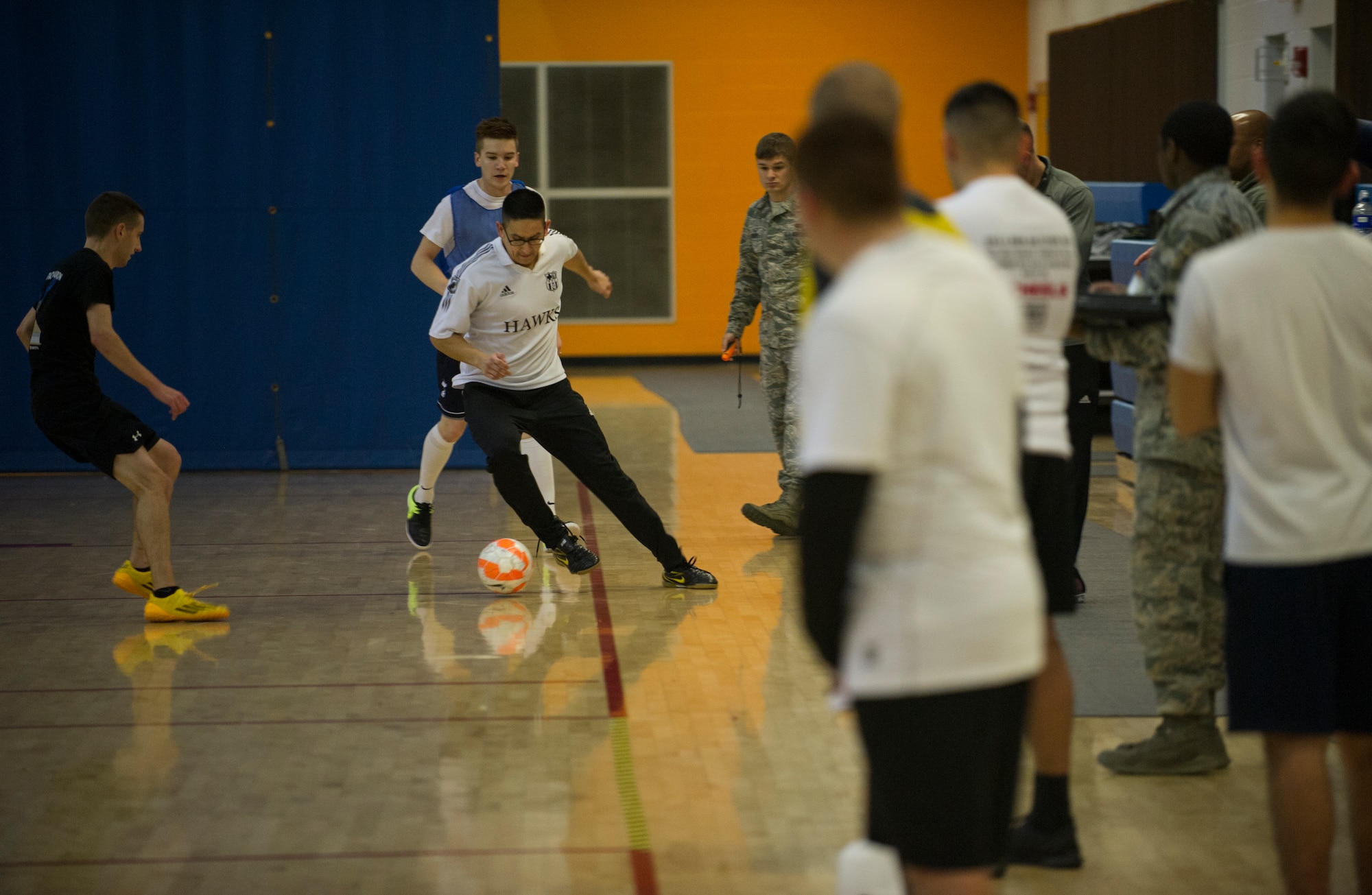 An Airman from the 5th Medical Group controls the ball during the intramural indoor soccer championship at Minot Air Force Base, N.D., Nov. 24, 2015. The game between the 5th MDG and 5th Contracting Squadron resulted in a win for 5th CONS. (U.S. Air Force photo/Senior Airman Apryl Hall)