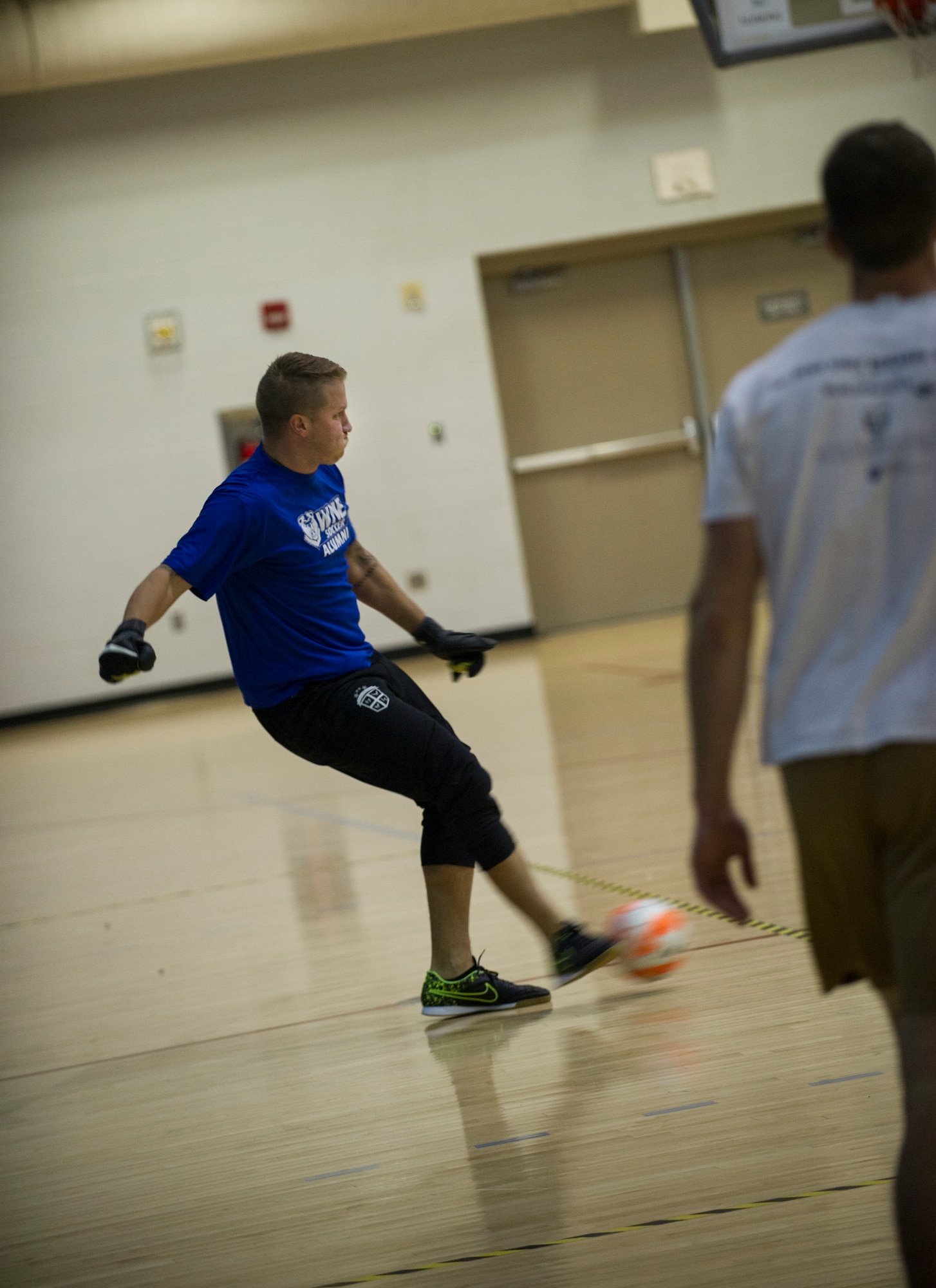Senior Airman Rian Praleikas, 5th Medical Support Squadron, kicks the ball during the intramural indoor soccer championship at Minot Air Force Base, N.D., Nov. 24, 2015. Praleikas played goalie for the 5th Medical Group team, which ended up losing the game to the 5th Contracting Squadron. (U.S. Air Force photo/Senior Airman Apryl Hall)