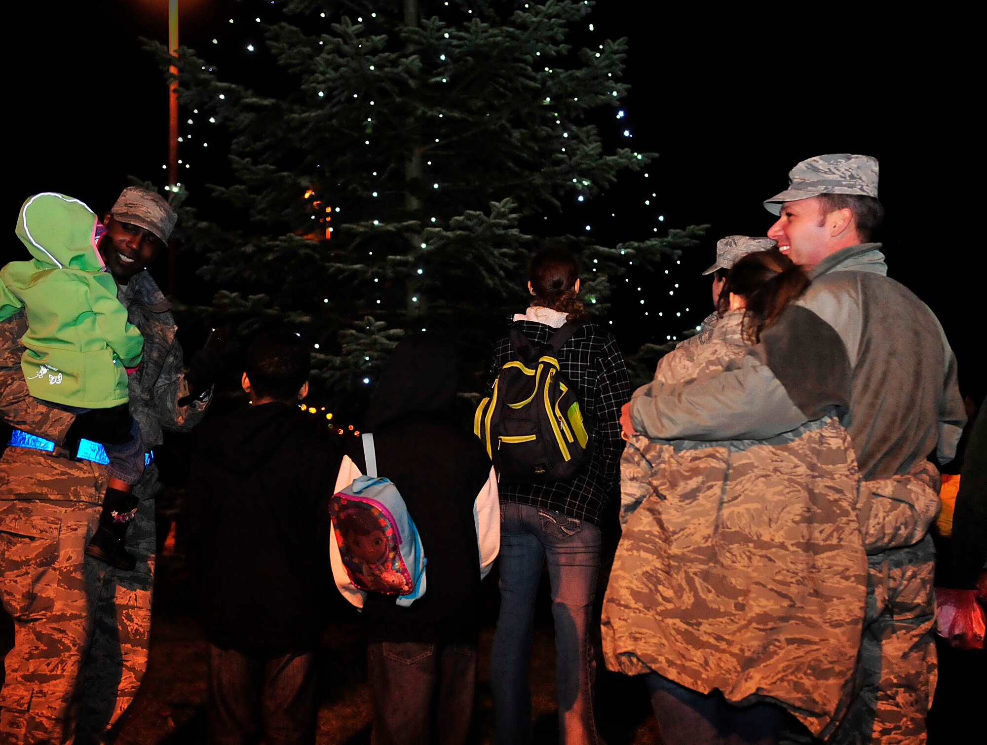 Families from the Kaiserslautern Military Community gather around for a tree lighting ceremony Nov. 30, 2015, at Ramstein Air Base, Germany. The ceremony consisted of performances from the U.S. Air Forces in Europe Band, the Blackbirds Chamber Choir and the Ramstein Liturgical Service Bell Choir. Following the ceremony, KMCC members were invited to the Ramstein Officer’s Club for a meet-and-greet with Santa Claus, which included cookies and hot cocoa. (U.S. Air Force photo/Airman 1st Class Larissa Greatwood)