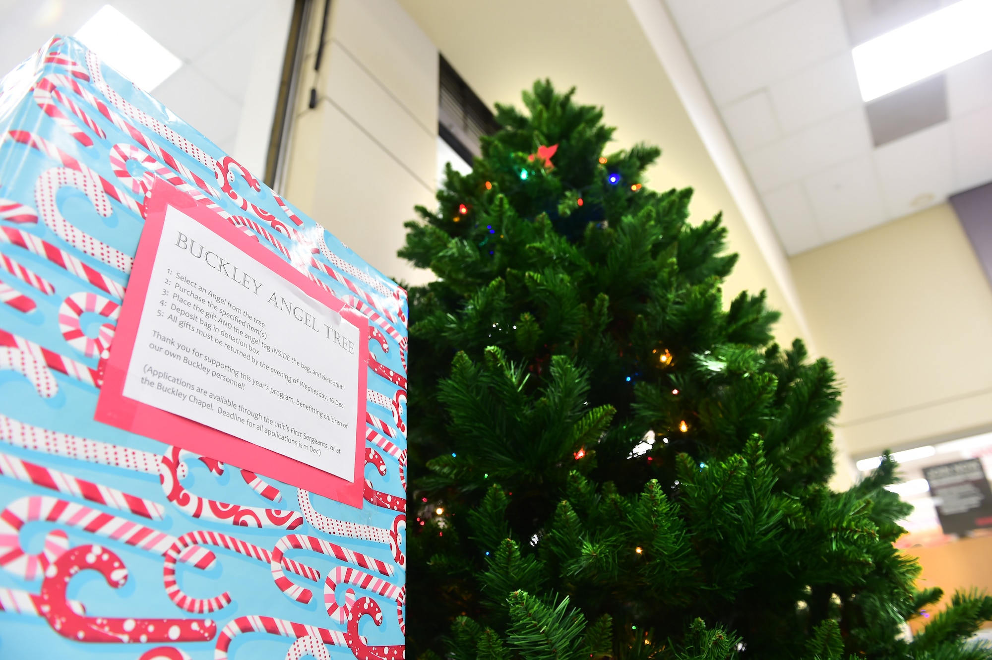 The Buckley Angel Tree stands in the Exchange for the holiday season Nov. 30, 2015, on Buckley Air Force Base, Colo.  The Angel Tree is a program set up by the Buckley Spouses Group and Buckley First Sergeants Council that helps Airmen and their families provide gifts for their children when finances are tight. (U.S. Air Force photo by Airman 1st Class Luke W. Nowakowski/Released)