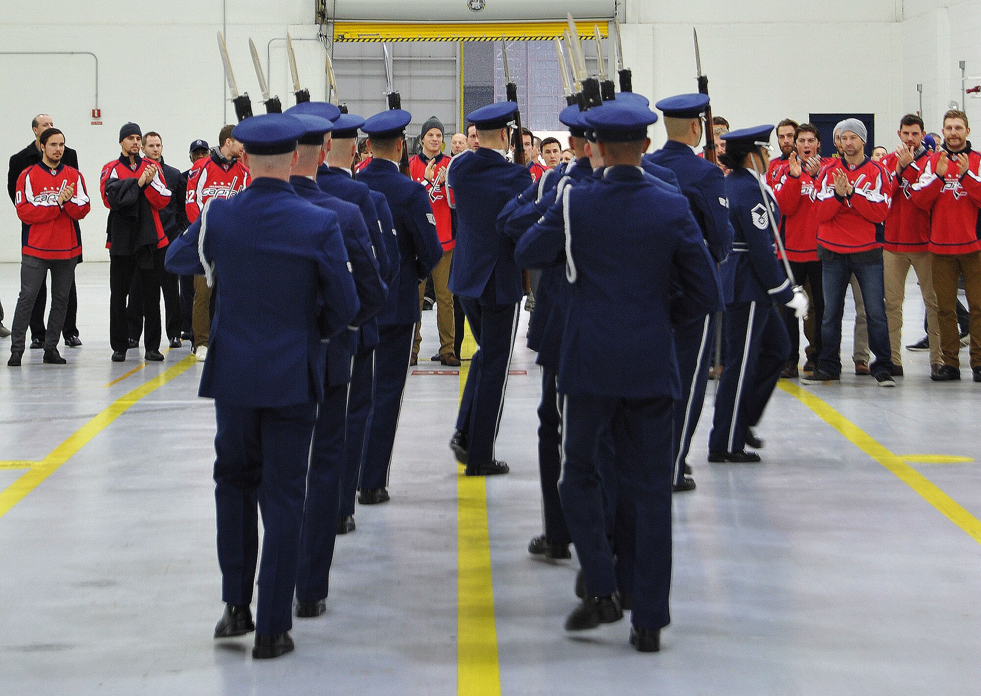Members of the U.S. Air Force Honor Guard perform for the Washington Capitals during the team’s tour of Joint Base Andrews Dec. 1, 2015. The visit included performances by the U.S. Air Force Band and the Air Force Honor Guard, aircraft tours, team-building activities, a demonstration by the Security Forces military working dogs, and lunch at the Joint Base Andrews Dining Facility.