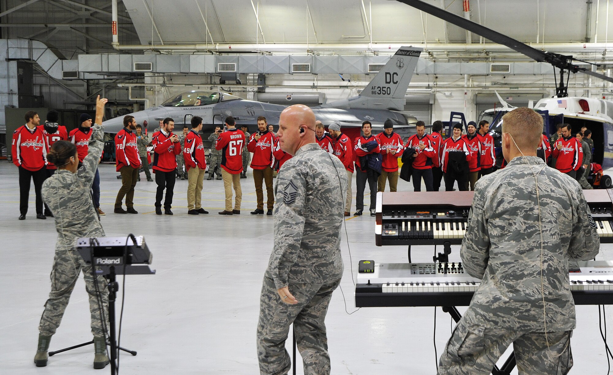 The members of the U.S. Air Force Band’s Max Impact perform for the Washington Capitals during the team’s tour of Joint Base Andrews Dec. 1, 2015.  The visit included performances by the U.S. Air Force Band and the Air Force Honor Guard, aircraft tours, team-building activities, a demonstration by the Security Forces military working dogs, and lunch at the Joint Base Andrews Dining Facility.