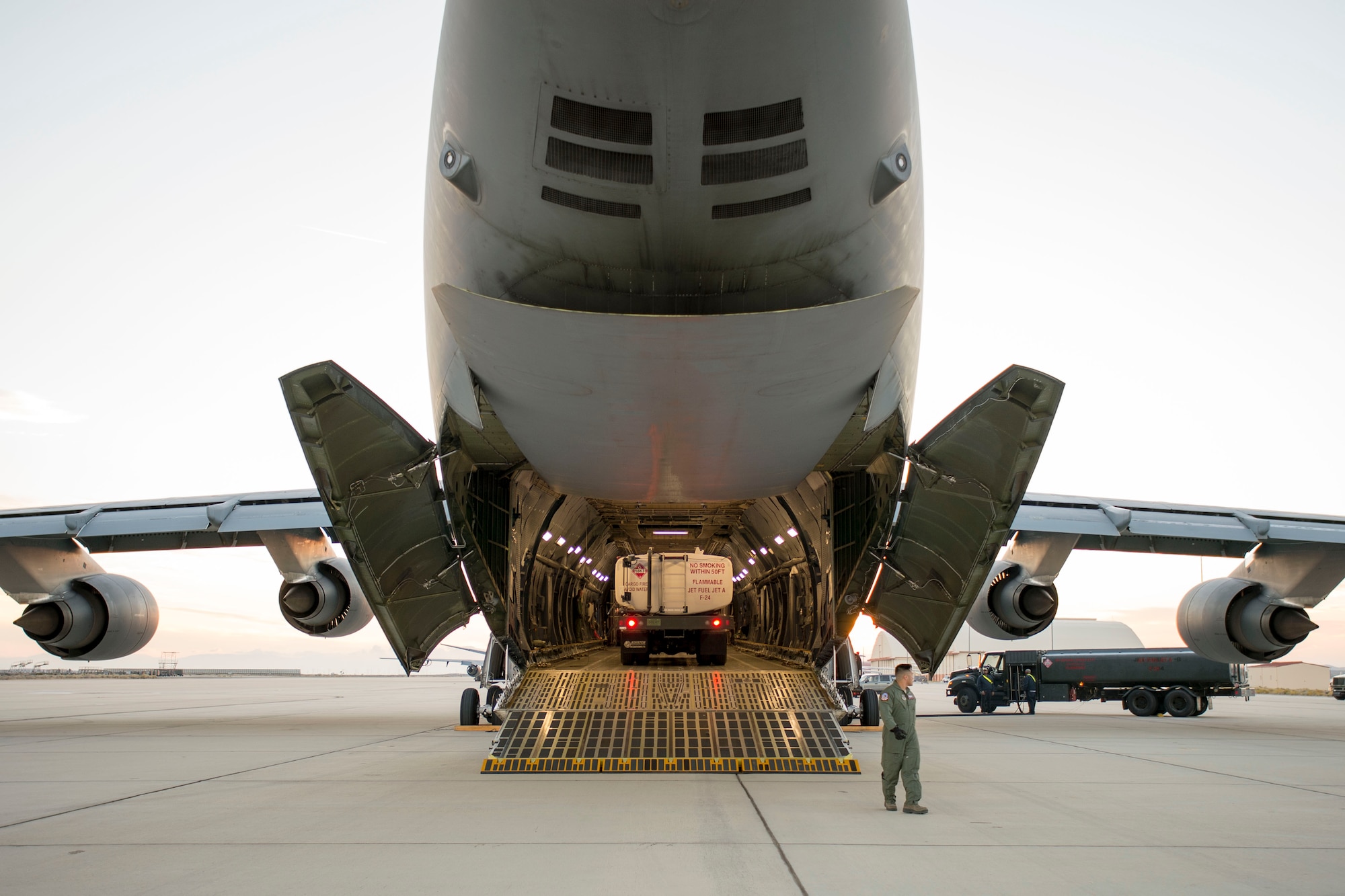 A C-5 Super Galaxy cargo plane from Travis Air Force Base, California, is loaded with three fuel trucks belonging to the 412th Logistics Readiness Squadron Nov. 23. The purpose of the deployment tasking was to assist President Barack Obama's visit to Paris for the 2015 United Nations Climate Change Conference. The fuel trucks could be used to refuel to refuel the president's plane, Air Force One. (U.S. Air Force photo by Ethan Wagner)