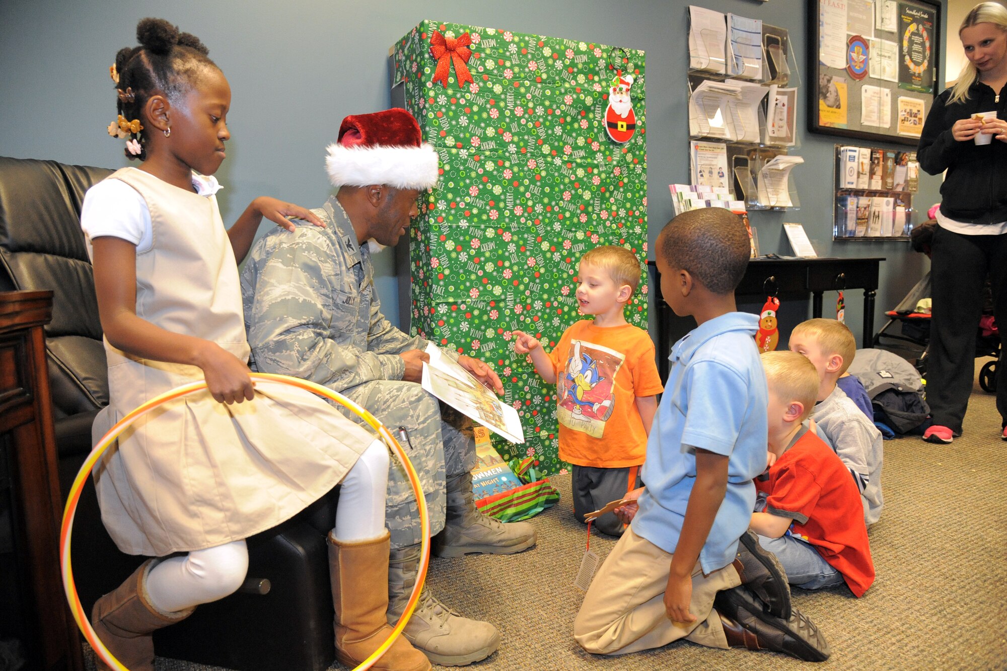 Col. Ronald Jolly, 75th Air Base Wing commander, reads Christmas stories to children during the Hill Air Force Base’s annual Christmas tree lighting celebration, Nov. 30. Other events included a tree lighting, visit from Santa, cookies and cocoa, and crafts.