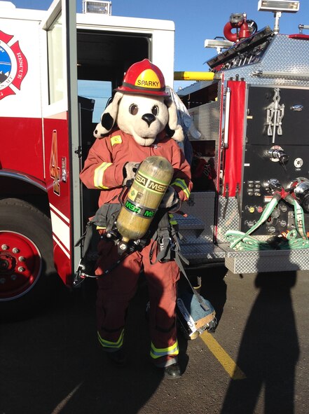 “Sparky” the fire dog steps out of a fire truck during an educational visit by members of the 120th Airlift Wing’s Fire Department to a school in Cascade County, Mont. (Photo by Terry Rutherford/Released)