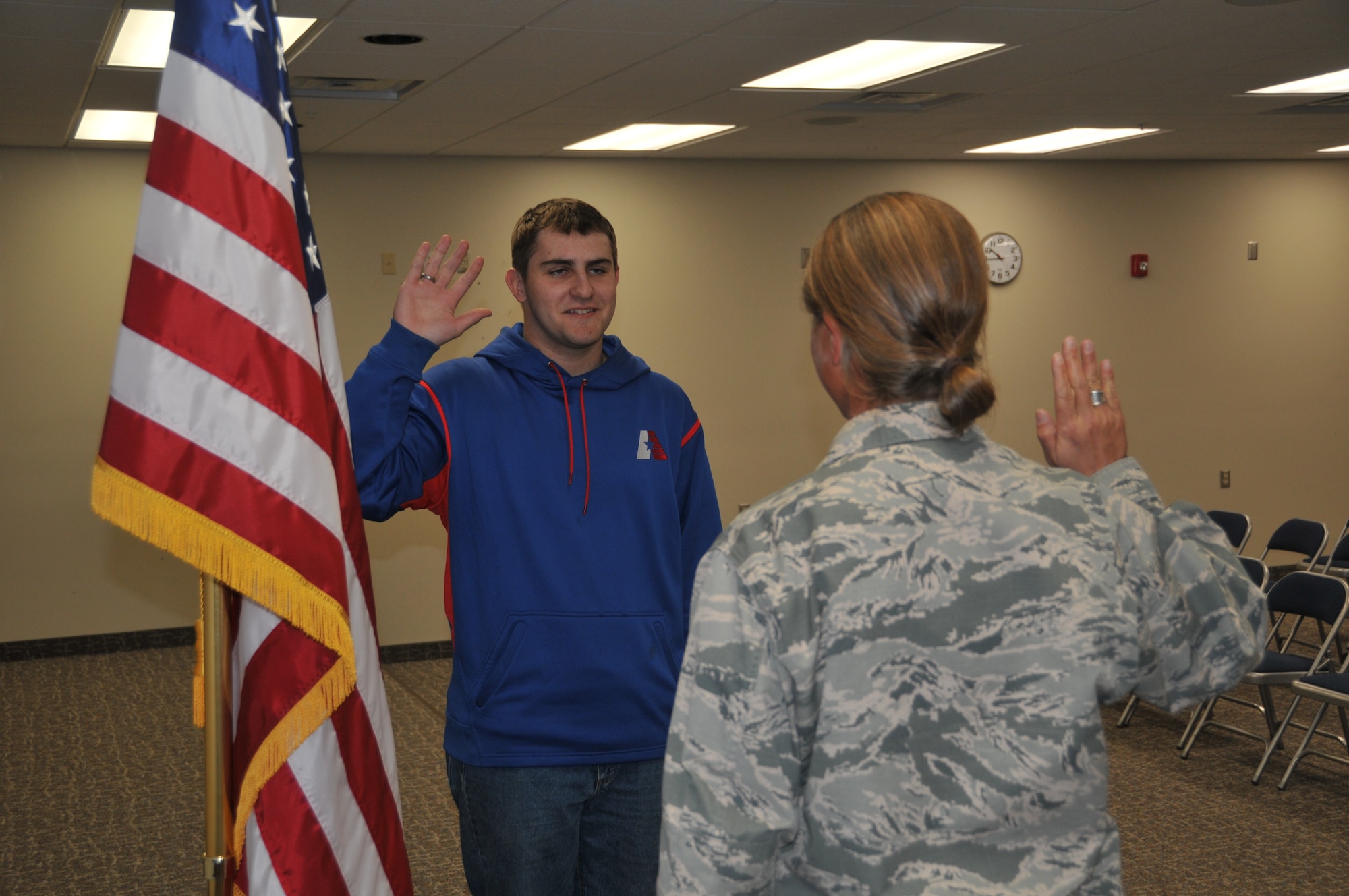 120th Logistics Readiness Squadron Commander Lt. Col. Jennifer Cinq-Mars administers the oath of enlistment to Eric Fletcher in the Larsen Room of the 120th Airlift Wing Headquarters Building on Oct. 30, 2015. (U.S. Air National Guard photo by Senior Master Sgt. Eric Peterson/Released)