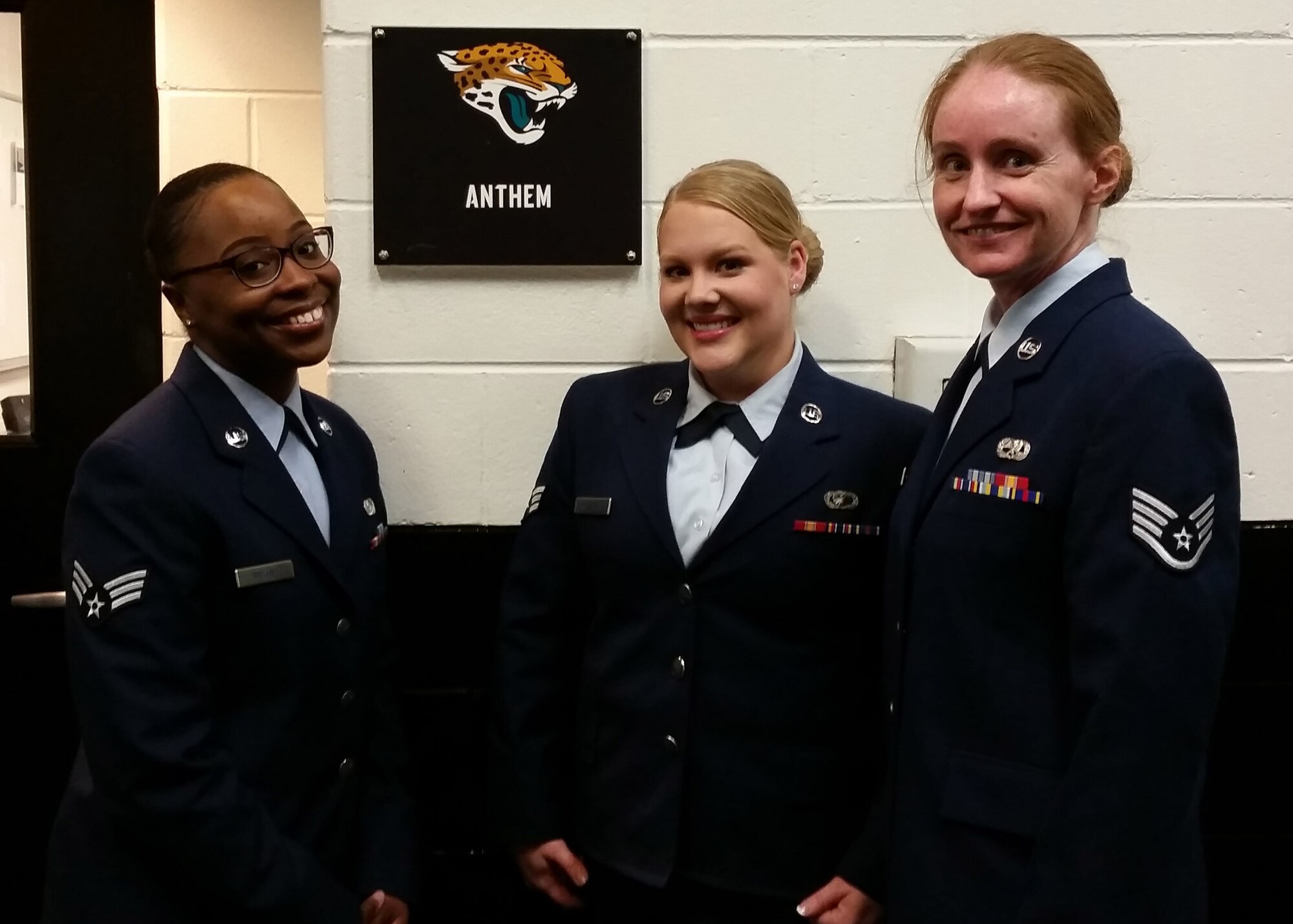 Senior Airman Asia Bryant (left), Senior Airman Kaleigh Kozdras and Staff Sgt. Carlynne Devine pose for a photo before the Jacksonville Jaguars Salute to Service game on November 29, 2015 at Everbank Field; Jacksonville, Florida.  (Courtesy photo)