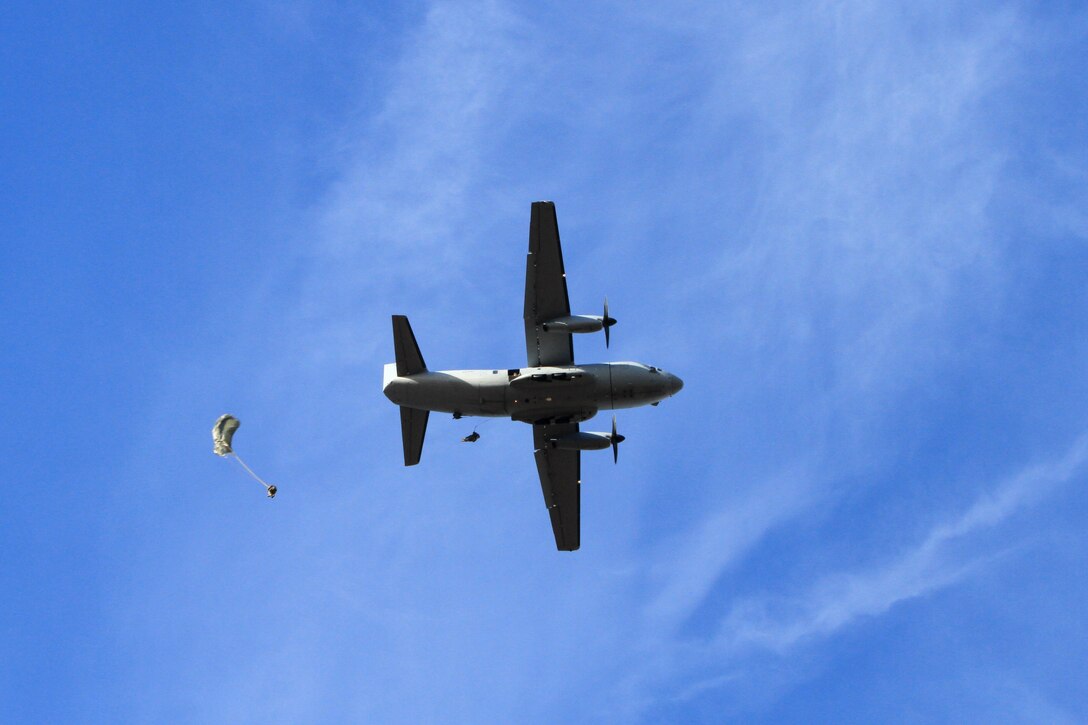 Paratroopers jump from a C-27 Spartan aircraft over St. Mere-Eglise drop zone, during airborne operations on Fort Bragg, N.C., Nov. 25, 2015. The paratroopers are assigned to the 112th Signal Battalion, 528th Special Operations Sustainment Brigade, Airborne. U.S. Army photo by Spc. Kevin A. Kim