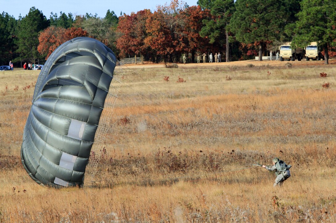A paratrooper recovers his parachute after completing his jump during airborne operations on Fort Bragg, N.C., Nov. 25, 2015. U.S. Army photo by Spec. Kevin A. Kim