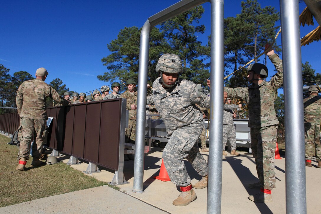 Army Capt. Collins, foreground, rehearses door checks before conducting airborne operations over St. Mere-Eglise drop zone on Fort Bragg, N.C., Nov. 25, 2015. Collins is assigned to the 112th Signal Battalion, 528th Special Operations Sustainment Brigade, Airborne. U.S. Army photo by Sgt. 1st Class Sean A. Foley