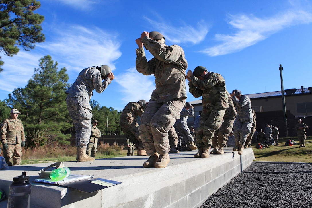 Paratroopers practice their parachute landing fall before conducting airborne operations over St. Mere-Eglise drop zone on Fort Bragg, N.C., Nov. 25, 2015. U.S. Army photo by Sgt. 1st Class Sean A. Foley