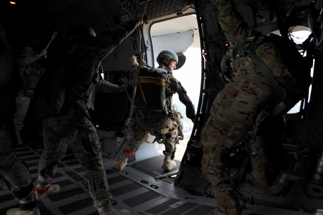 Army Capt. Schildroth, center, checks the troop door of a C-27 Spartan aircraft during airborne operations over St. Mere-Eglise drop zone on Fort Bragg, N.C., Nov. 25, 2015. Schildroth is an Army Chaplain assigned to the 112th Signal Battalion, 528th Special Operations Sustainment Brigade, Airborne. U.S. Army photo by Sgt. 1st Class Sean A. Foley