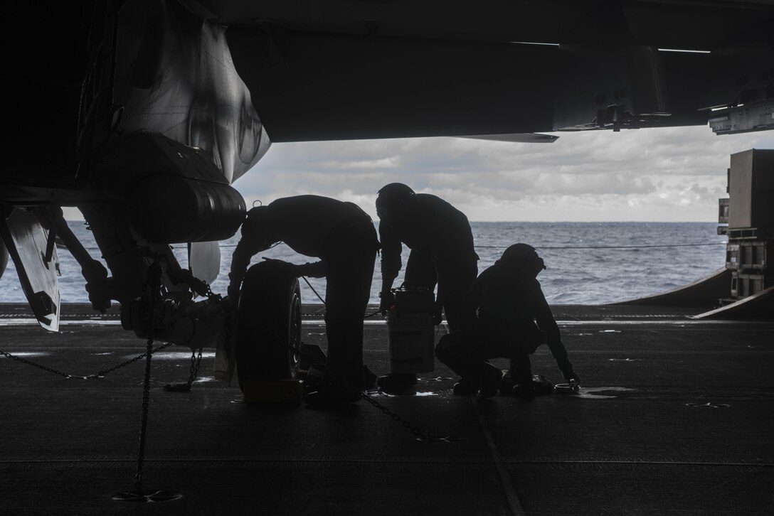 U.S. sailors conduct maintenance on the landing gear of an F/A-18F Super Hornet in the hangar bay of the aircraft carrier USS Dwight D. Eisenhower in the Atlantic Ocean, Nov. 25, 2015. U.S. Navy photo by Seaman Apprentice Casey S. Trietsch