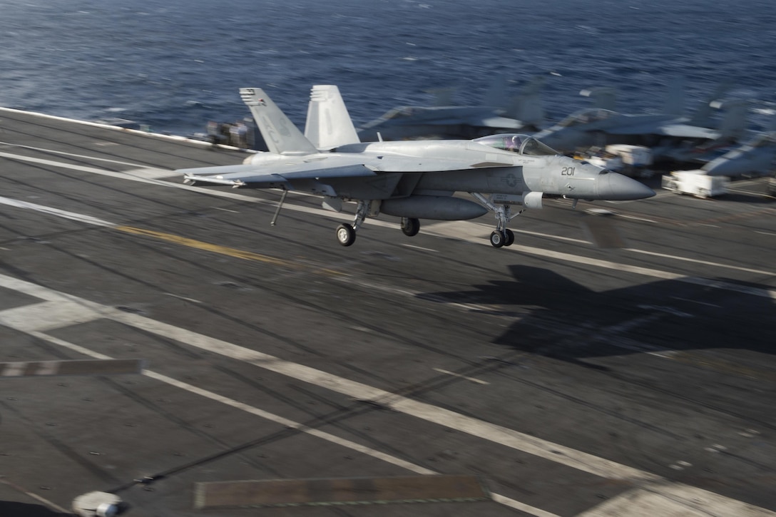 An F/A-18E Super Hornet assigned to the Sidewinders of Strike Fighter Squadron 86 prepares to make an arrested landing on the flight deck of the aircraft carrier USS Dwight D. Eisenhower in the Atlantic Ocean, Nov. 27, 2015. U.S. Navy photo by Seaman Anderson W. Branch