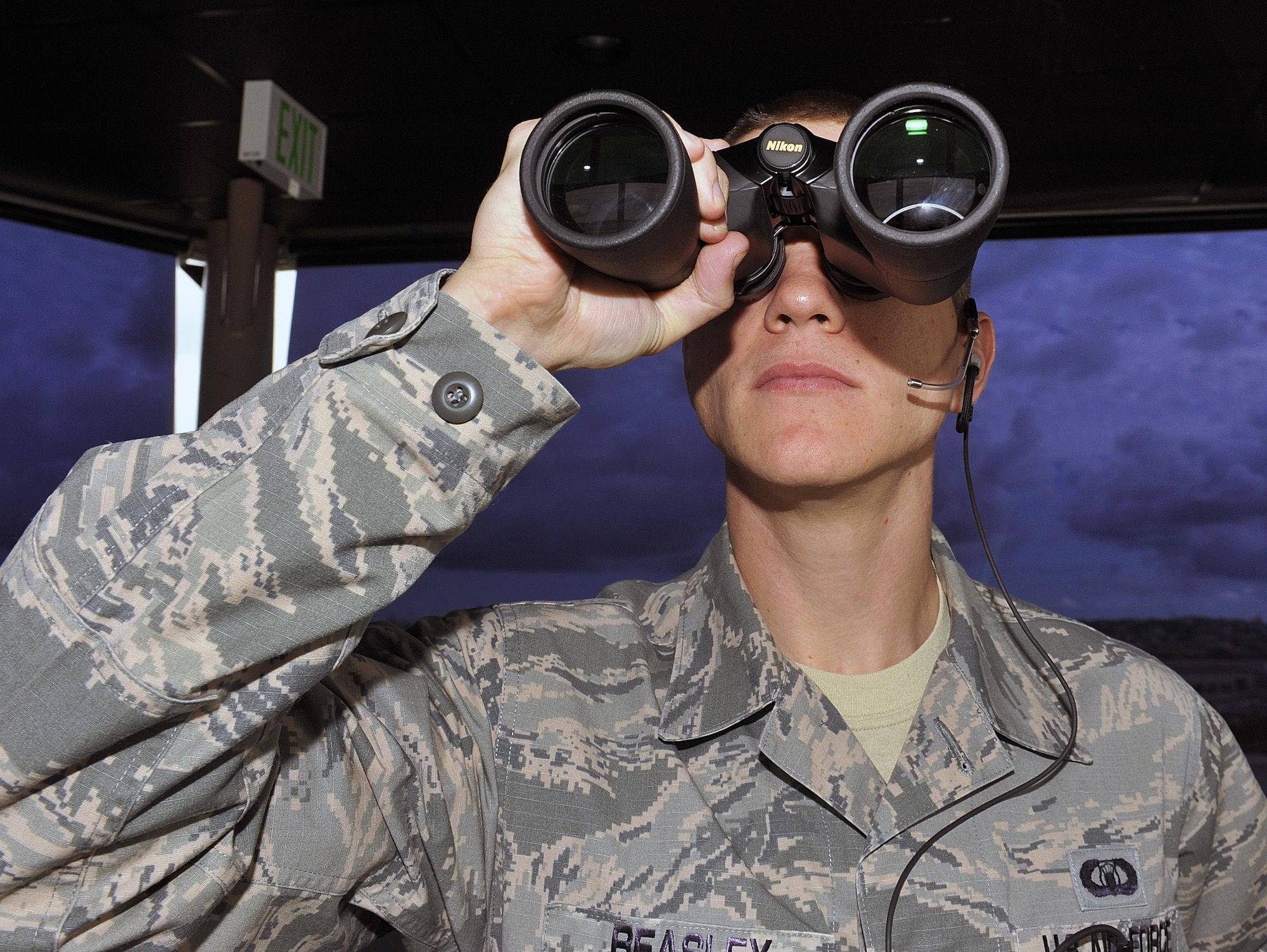 U.S. Air Force Staff Sgt. Dennis Beasley, 18th Operations Support Squadron air traffic controller, monitors an outbound aircraft, Nov. 30, 2015, at Kadena Air Base, Japan. The ATC tower provides air traffic controllers the best view to ensure aircraft arrive and depart safely. (U.S. Air Force photo by Naoto Anazawa/Released)