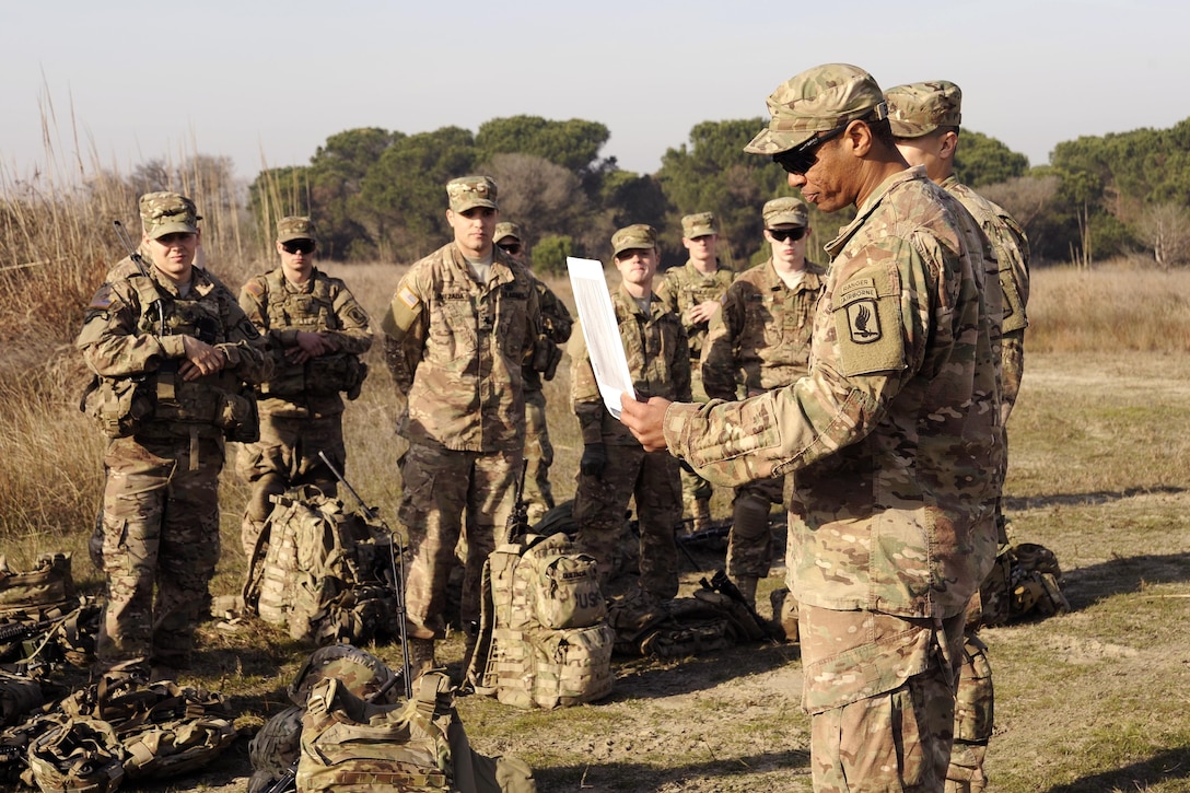 U.S. Army 2nd Lt. Joseph T. Edwards Jr. gives a mission brief before his soldiers participate in zero and qualification on the M249 light machine gun and M4 carbine at Force Reno Training Area, Ravenna, Italy, Nov. 30, 2015. Edwards is assigned to Company C, 1st Battalion, 503rd Infantry Regiment, 173rd Airborne Brigade. U.S. Army photo by Elena Baladelli