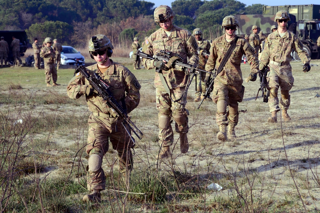 U.S. paratroopers move out to the firing line before participating in zero and qualification on the M249 light machine gun and M4 carbine at Force Reno Training Area, Ravenna, Italy, Nov. 30, 2015. U.S. Army photo by Elena Baladelli