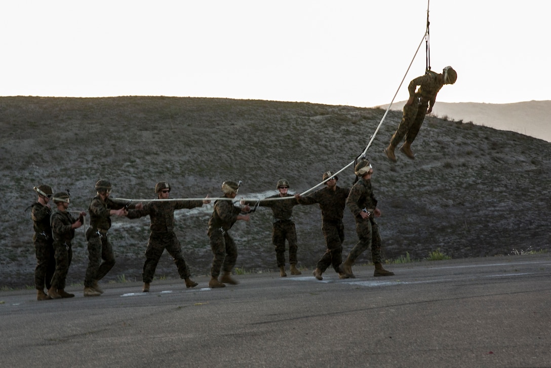 Marines are lifted from the ground one by one during Special Patrol Insertion and Extraction rigging training on Camp Pendleton, Calif., Nov. 19, 2015. U.S. Marine Corps photo by Cpl. Briauna Birl