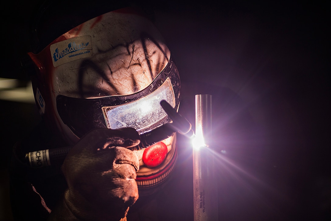 Navy Seaman Quinton Mems welds a handrail in the machinery shop aboard aircraft carrier USS George Washington 
in Atlantic City, Nov. 30, 2015. Washington and its embarked air wing, Carrier Air Wing 2, are deployed to support Southern Seas 2015. U.S. Navy photo by Seaman Clemente A. Lynch