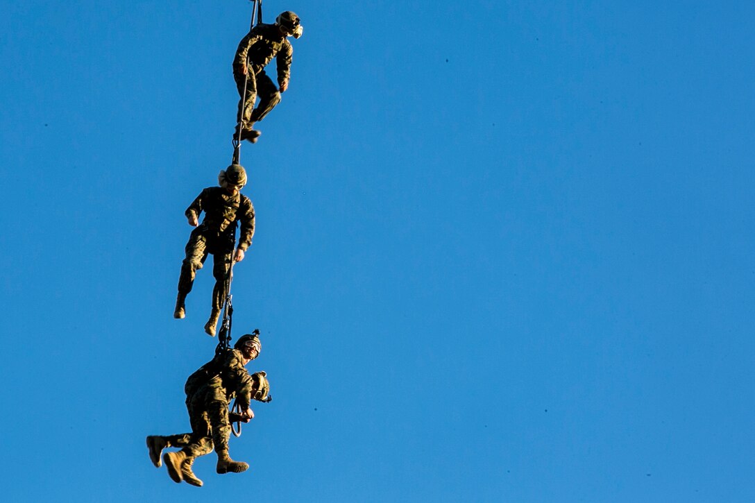 Marines are being lifted to a height of over 350 feet in the air to avoid any possible obstacles before flying around the area during insertion and extraction rigging training on Camp Pendleton, Calif., Nov. 19, 2015. U.S. Marine Corps photo by Cpl. Briauna Birl