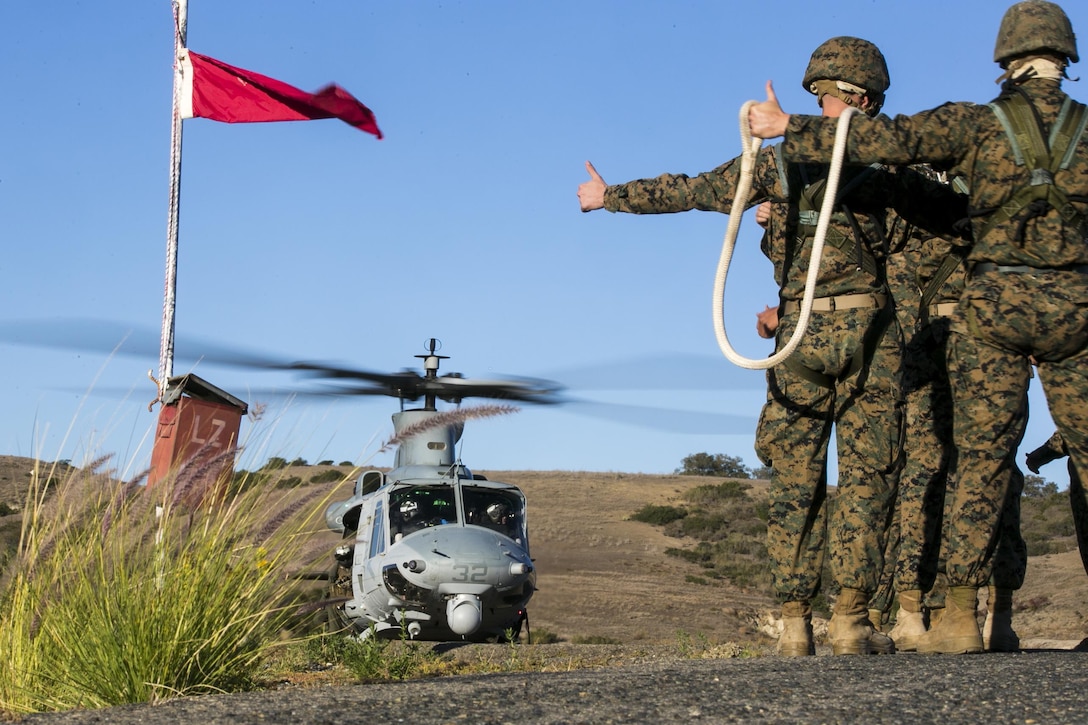 Marines wait to be lifted from the ground as they conduct insertion and extraction rigging training on Camp Pendleton, Calif., Nov. 19, 2015. U.S. Marine Corps photo by Cpl. Briauna Birl