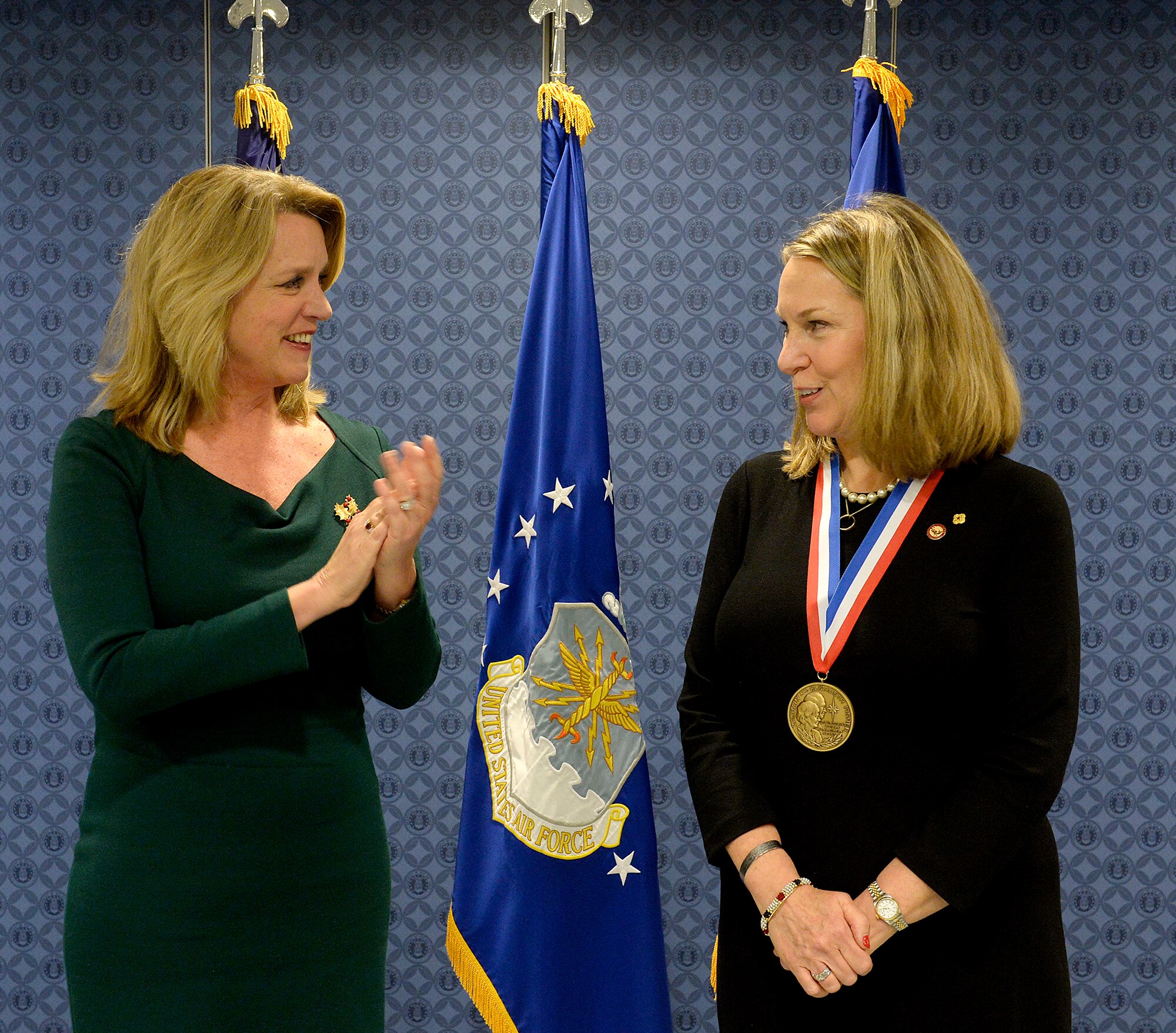 Secretary of the Air Force Deborah Lee James congratulates Bonnie Carroll, the founder and president of the Tragedy Assistance Program for Survivors, during a ceremony honoring Carroll with the Zachary and Elizabeth Fisher Distinguished Civilian Humanitarian Award in the Pentagon, Dec. 1, 2015. (U.S. Air Force photo/Scott M. Ash)