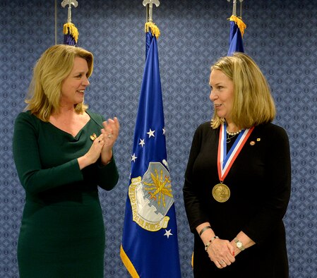 Secretary of the Air Force Deborah Lee James congratulates Bonnie Carroll, the founder and president of the Tragedy Assistance Program for Survivors, during a ceremony honoring Carroll with the Zachary and Elizabeth Fisher Distinguished Civilian Humanitarian Award in the Pentagon Dec. 1, 2015. (U.S. Air Force photo/Scott M. Ash)