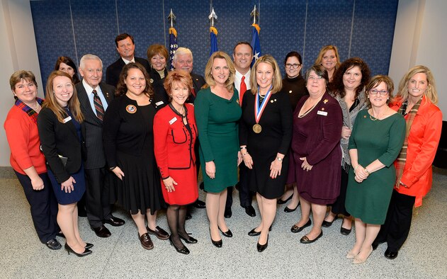 Secretary of the Air Force Deborah Lee James, center, congratulates Bonnie Carroll, the founder and president of the Tragedy Assistance Program for Survivors, during a ceremony honoring Carroll with the Zachary and Elizabeth Fisher Distinguished Civilian Humanitarian Award in the Pentagon Dec. 1, 2015. With James and Carroll are TAPS members who attended the ceremony. (U.S. Air Force photo/Scott M. Ash)