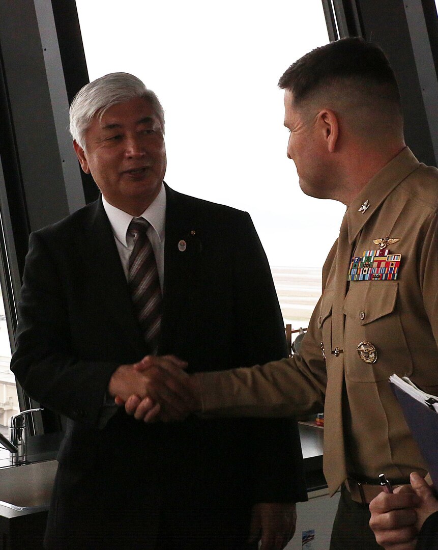Gen Nakatani, Japanese Defense Minister, thanks Col. Robert V. Boucher, commanding officer of Marine Corps Air Station Iwakuni, Japan, during a station visit to the air traffic control tower, Dec. 2, 2015. As part of the growing U.S. – Japan relationship, this visit provided Nakatani an opportunity to connect with station officials and view pertinent installation facilities that aid in the Marine Corps’ mission success.