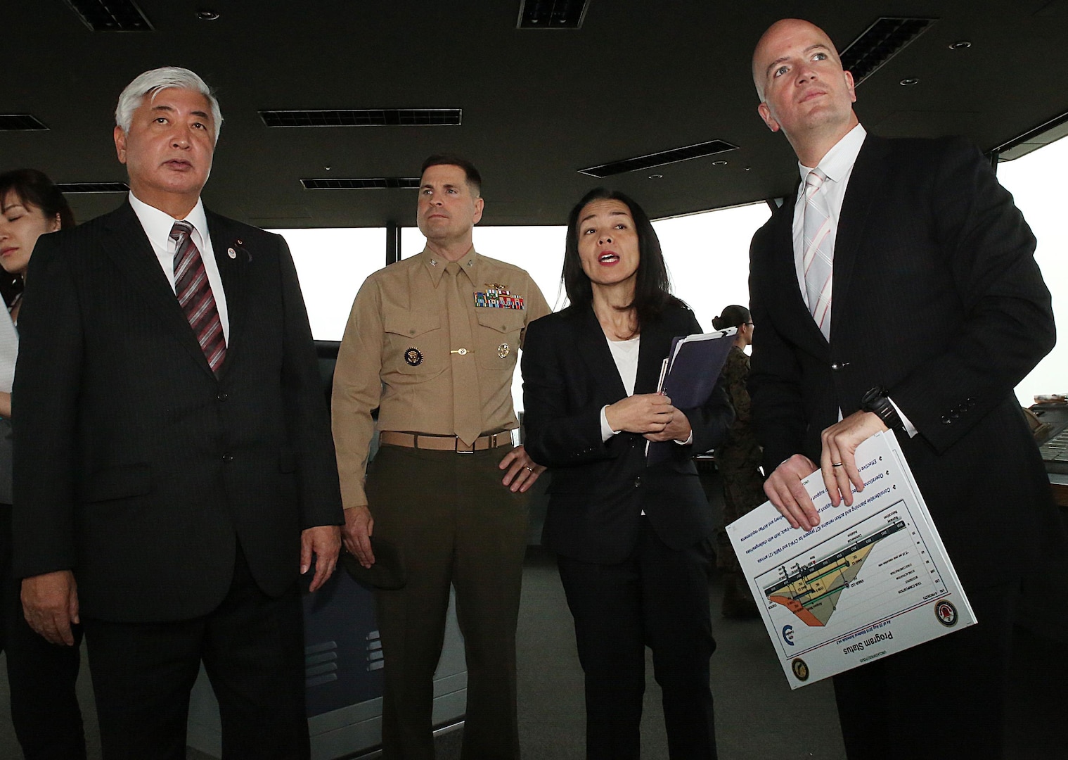 From left to right. Gen Nakatani, Japanese Defense Minister, tours the air traffic control tower with Col. Robert V. Boucher, commanding officer of Marine Corps Air Station Iwakuni, Japan, Yoko Seo, technical information specialist with protocol at Headquarters and Headquarters Squadron, and Brian Wottowa, director of Iwakuni's Integrated Program Management Office for the Defense Policy Review Initiative, during a station visit, Dec. 2, 2015. Station officials welcomed Nakatani before touring VMGR-152 and the air traffic control tower. This visit built a stronger bilateral understanding between station personnel and Japanese officials.

