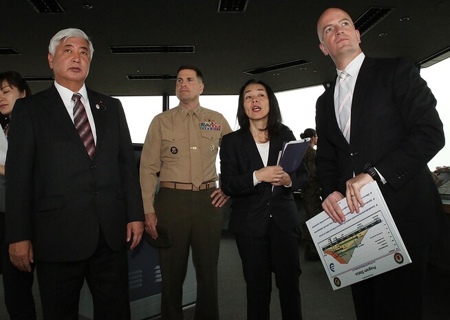 From left to right. Gen Nakatani, Japanese Defense Minister, tours the air traffic control tower with Col. Robert V. Boucher, commanding officer of Marine Corps Air Station Iwakuni, Japan, Yoko Seo, technical information specialist with protocol at Headquarters and Headquarters Squadron, and Brian Wottowa, director of Iwakuni's Integrated Program Management Office for the Defense Policy Review Initiative, during a station visit, Dec. 2, 2015. Station officials welcomed Nakatani before touring VMGR-152 and the air traffic control tower. This visit built a stronger bilateral understanding between station personnel and Japanese officials.
