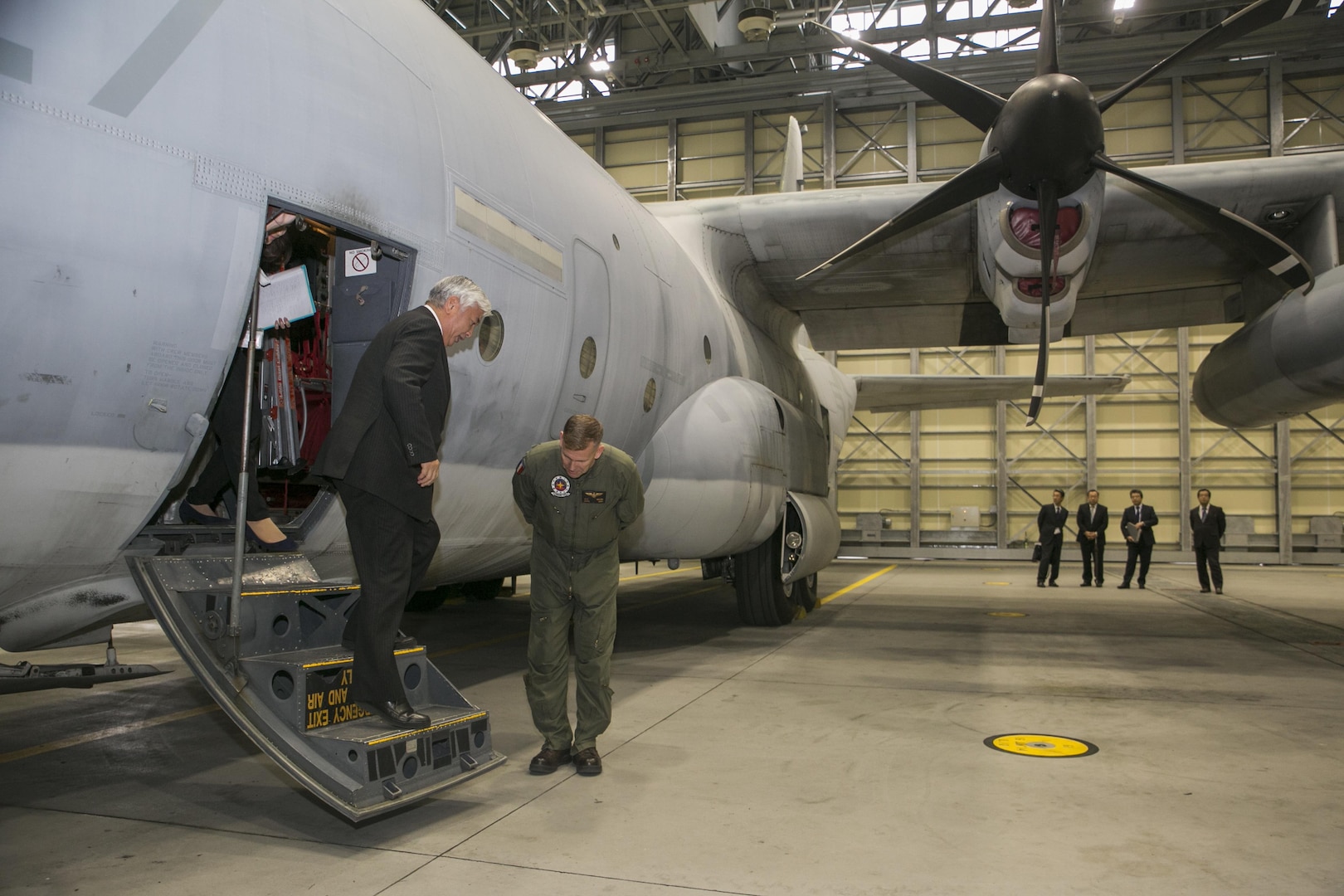 Gen Nakatani, Japanese Defense Minister, tours a KC-130J Super Hercules at Marine Aerial Refueler Transport Squadron (VMGR) 152 facilities during his visit to Marine Corps Air Station Iwakuni, Japan, Dec. 2, 2015. Station officials welcomed Nakatani before touring VMGR-152 and the air traffic control tower. This visit built a stronger bilateral understanding between station personnel and Japanese officials. (U.S. Marine Corps photo by Cpl. Carlos Cruz Jr./Released)