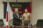 Colonel Robert V. Boucher, commanding officer of Marine Corps Air Station Iwakuni, Japan, greets Gen Nakatani, Japanese Defense Minister, during Nakatani’s visit to the air station, Dec. 2, 2015. As part of the growing U.S. – Japan relationship, this visit provided Nakatani an opportunity to connect with station officials and view pertinent installation facilities that aid in the Marine Corps’ mission success.