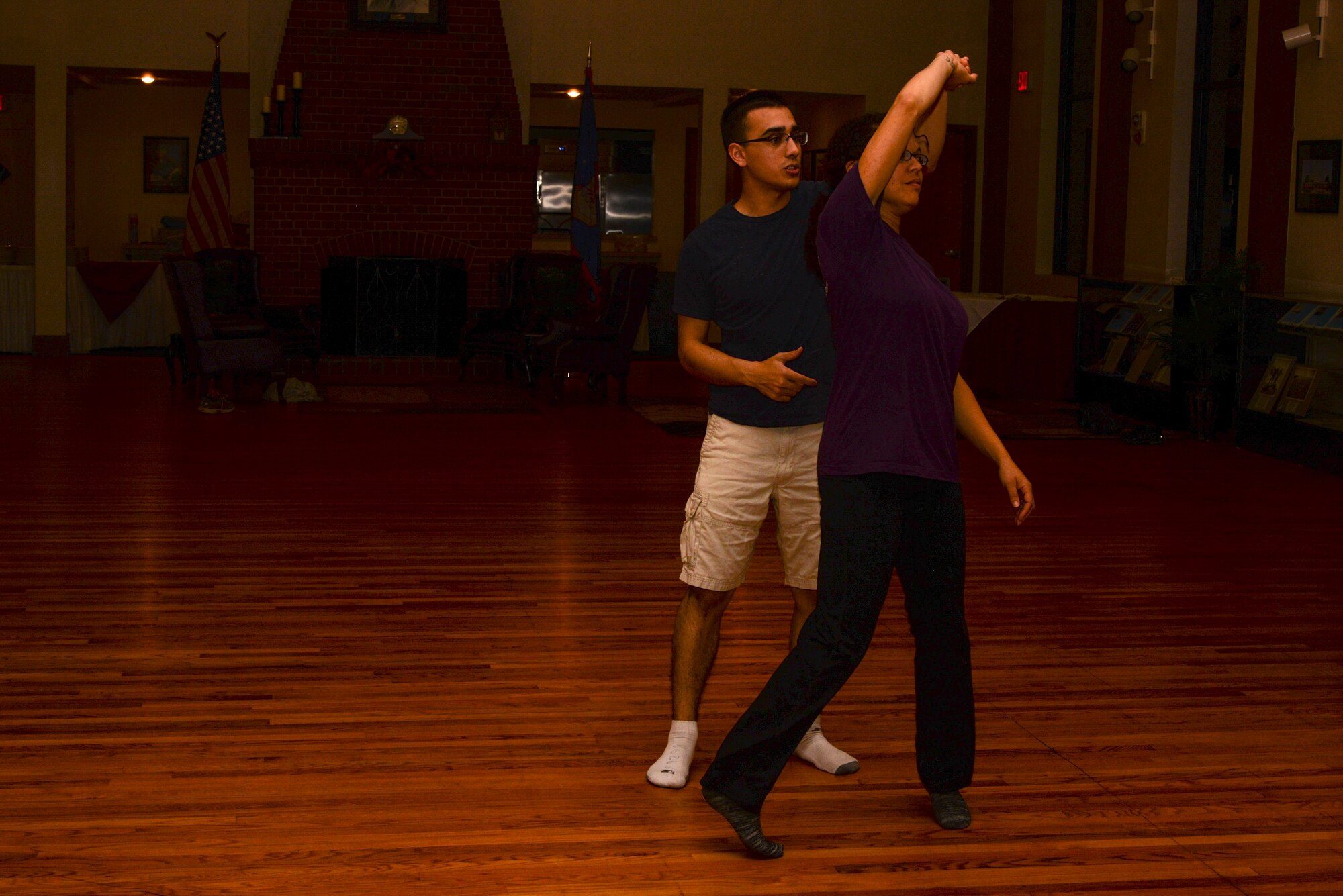 U.S. Air Force 2nd Lt. Simon Pena, 23d Force  Support Squadron fitness and sports officer, and Amber Dexheimer, 23d Force Support Squadron community programmer, demonstrate how the ”lead” should turn the “follow” during a swing dance class, Nov. 12, 2015, at Moody Air Force Base, Ga. The next class will be held Dec. 10 at the Heritage Hall and is offered as a chance for the Moody community to have fun and learn something new. (U.S. Air Force photo by Airman 1st Class Janiqua P. Robinson/Released)