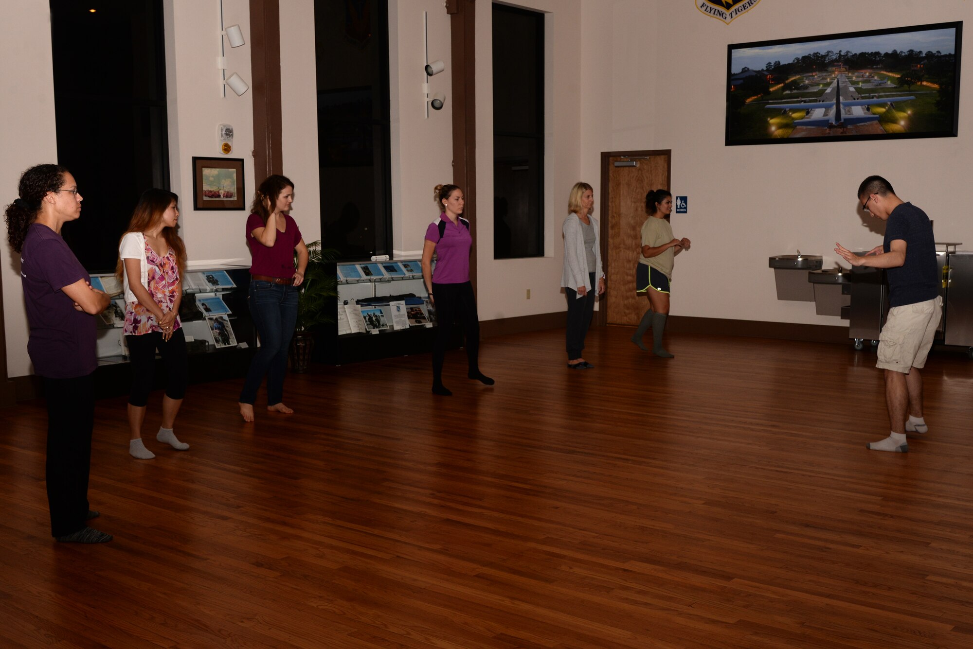 U.S. Air Force 2nd Lt. Simon Pena, 23d Force  Support Squadron fitness and sports officer, showcases how the “follow,” who is responsible for complimenting the lead, should move during a swing dance class, Nov. 12, 2015, at Moody Air Force Base, Ga. The next class is slated for Dec. 10, and attendees can walk-in or pre-register at the Spot by calling 229-257-9215. (U.S. Air Force photo by Airman 1st Class Janiqua P. Robinson/Released)
