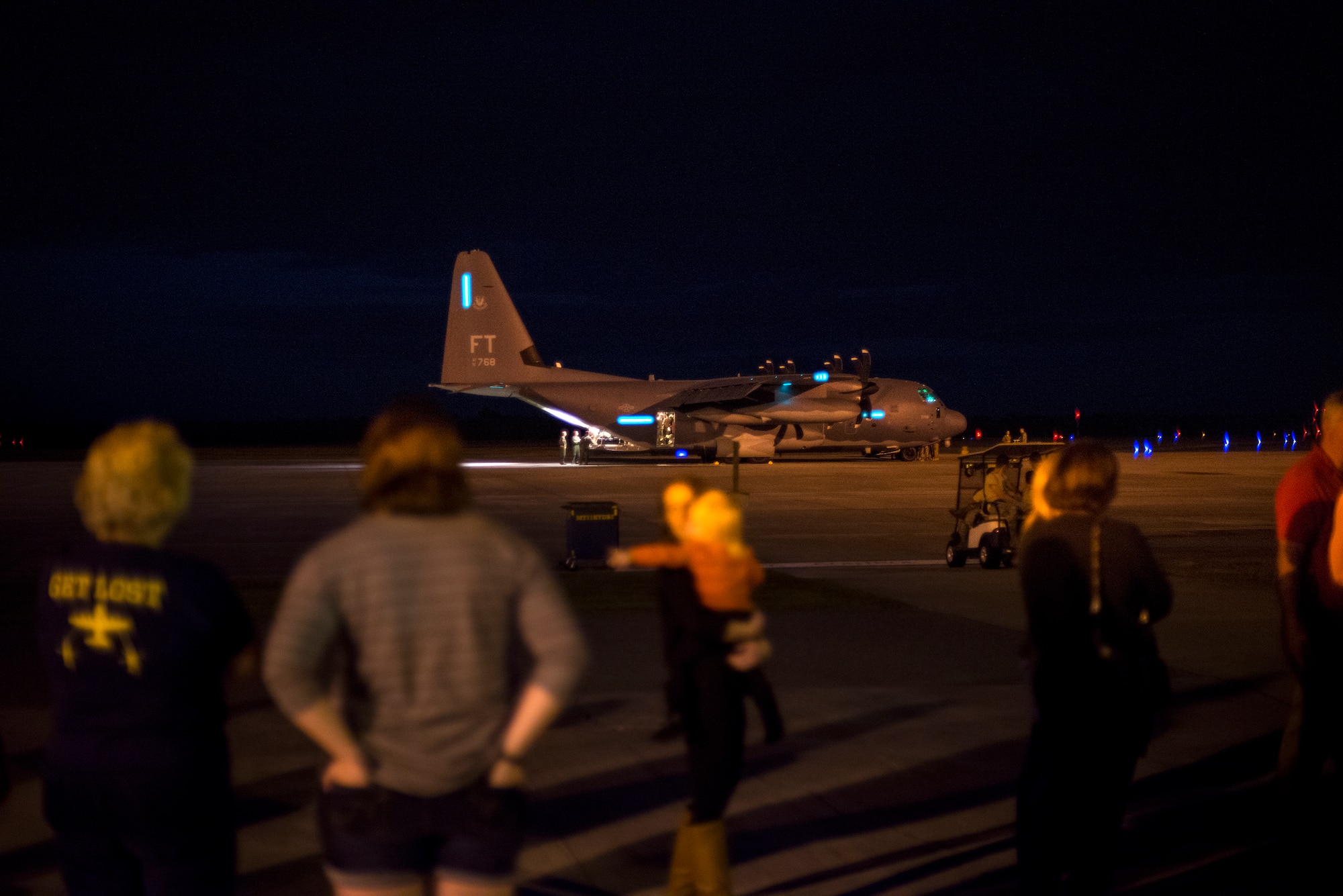 Friends and family of deploying Airmen watch as an HC-130J Combat King II prepares to taxi, Nov. 27, 2015, at Moody Air Force Base, Ga. The Airmen are deploying for six months in support of Operation Inherent Resolve. (U.S. Air Force photo by Senior Airman Ryan Callaghan/Released)
