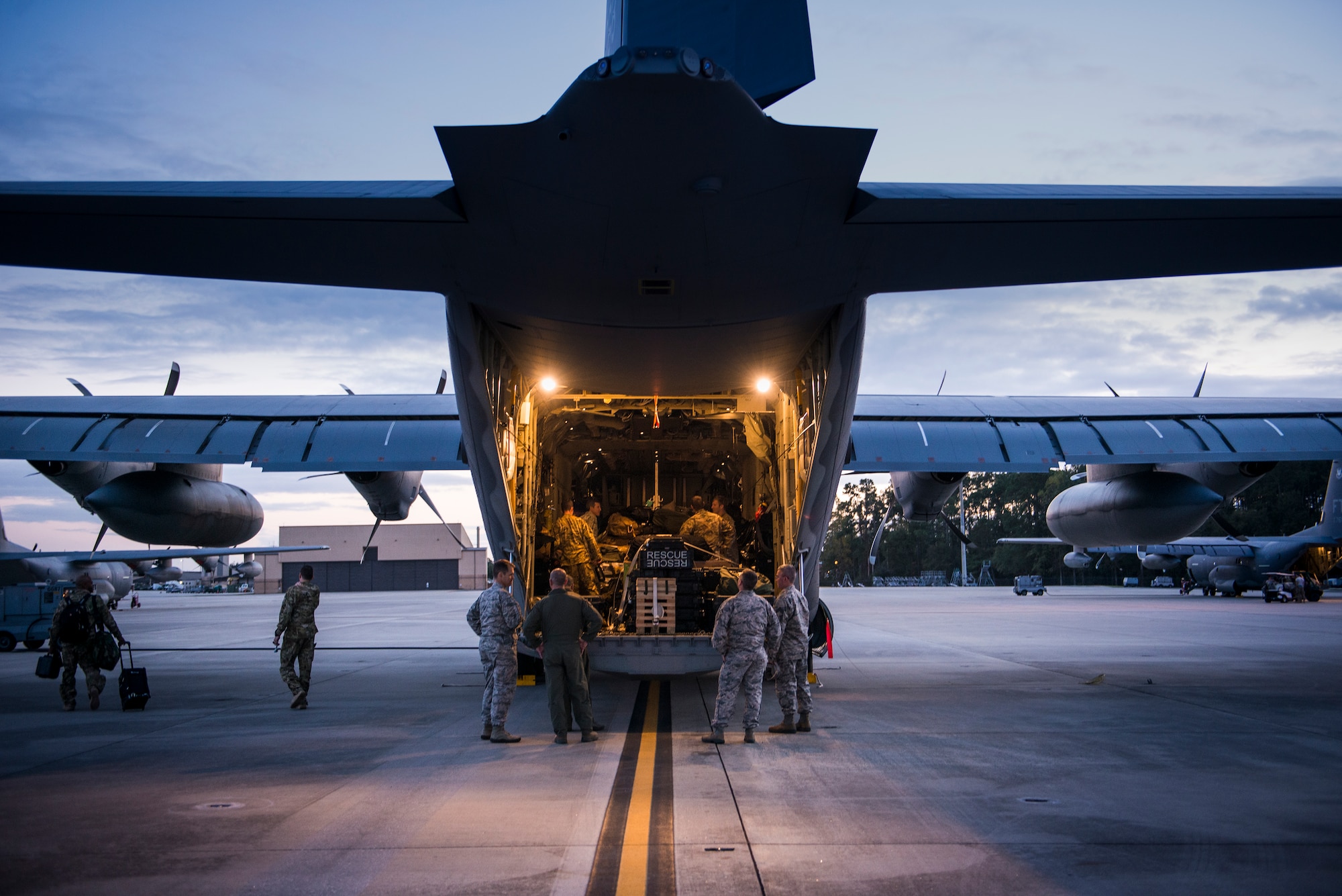Airmen from the 71st Rescue Squadron secure cargo in the back of an HC-130J Combat King II, Nov. 27, 2015, at Moody Air Force Base, Ga. The Airmen prepared to deploy in support of Operation Inherent Resolve. (U.S. Air Force photo by Senior Airman Ryan Callaghan/Released)