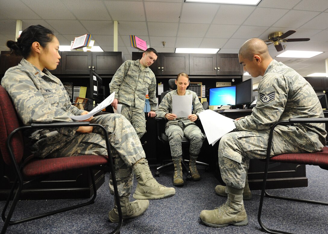 325th Comptroller Squadron personnel discuss proper training techniques to improve customer service Nov. 25 at the Base Support Center. They serve as liaison between base organizations and the Defense Finance and Accounting Service, which is responsible for payments to commercial vendors and government agencies. (U.S. Air Force photo by Senior Airman Ty-Rico Lea/Released)