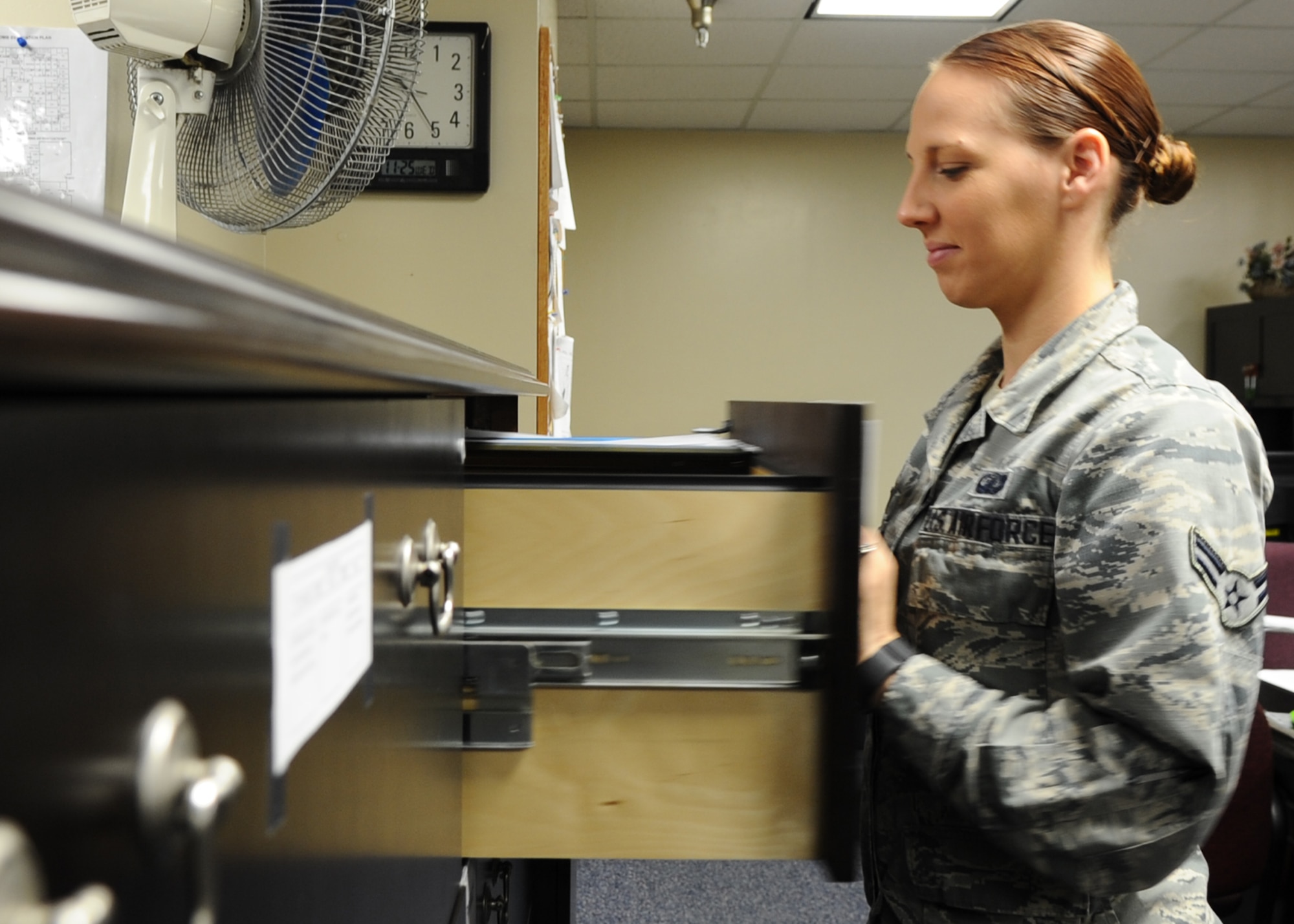 Airman 1st Class Elizabeth Davis, 325th Comptroller Squadron financial services technician, prepares to organize files regarding financial documentation from service members Nov. 25 at the Base Support Center. The Customer Service section provides pay, allowances and entitlement assistance. (U.S. Air Force photo by Senior Airman Ty-Rico Lea/Released)