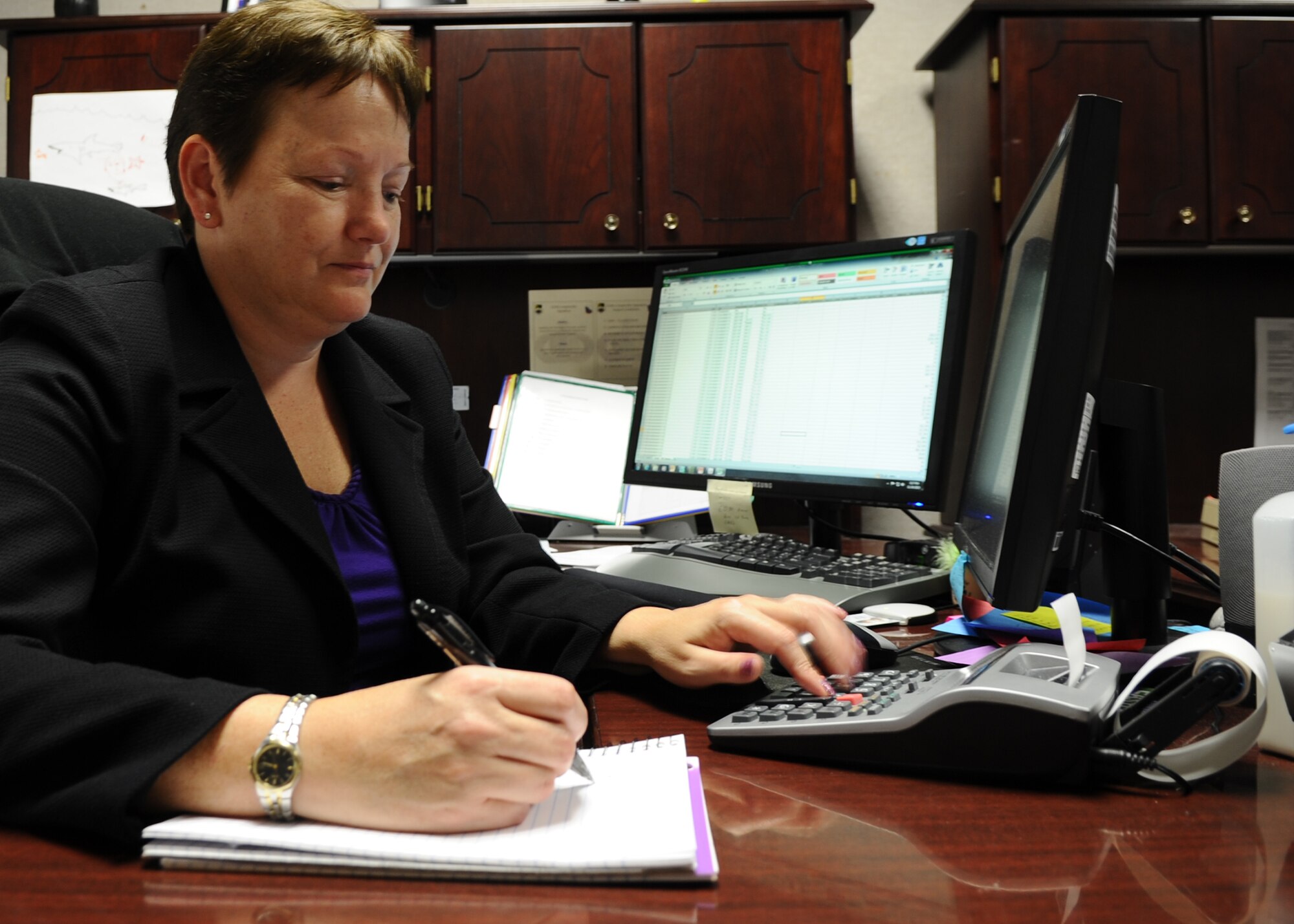 Vivian Clark, 325th Comptroller lead budget analyst, evaluates the fiscal year 2016 budget execution plan for the 325th Fighter Wing Nov. 24 at the Financial Analysis Flight. The importance for creating this plan is to assist the wing commander in managing allocated resources and achieving the wing's mission. (U.S. Air Force photo by Senior Airman Ty-Rico Lea/Released)