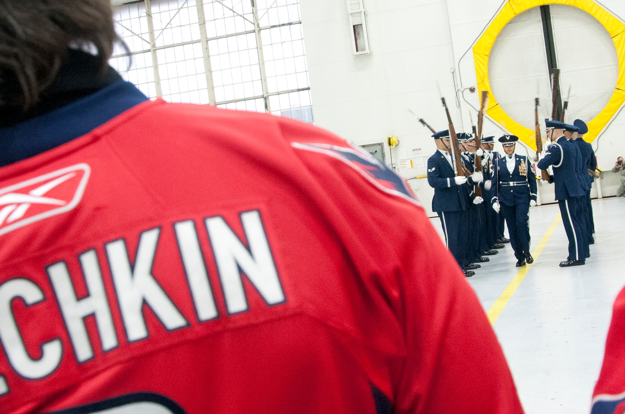 Alex Ovechkin, Washington Capitals left forward, observes a performance by the U.S. Air Force Honor Guard in a 459th Air Refueling Wing hangar on Joint Base Andrews, Md., Dec. 1, 2015. The Capitals visited JBA to learn about the Air Force mission here. They observed special performances by the U.S. Air Force band Max Impact, Honor Guard, 11th Wing Explosive Ordnance Disposal, as well as static displays from the 459 ARW, 1st Helicopter Squadron and 113th Wing, Air National Guard. (U.S. Air Force photo by Staff. Sgt. Kat Justen)