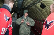 Tech. Sgt. Erica Knight, 756th Air Refueling Squadron boom operator, describes how to manually descend the landing gear from a KC-135R Stratotanker to members of the Washington Capitals during the team’s visit to Joint Base Andrews Dec. 1, 2015. The Capitals visited JBA to learn about the Air Force mission.  They observed special performances by the U.S. Air Force band Max Impact, Honor Guard, 11th Wing Explosive Ordnance Disposal, as well as static displays from the 459 ARW, 1st Helicopter Squadron and 113th Wing, Air National Guard. (U.S. Air Force photo by Staff. Sgt. Kat Justen)