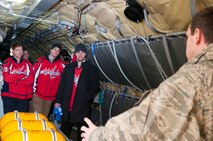 Technical Sgt. Matt Oberlin, 756th Air Refueling Squadron boom operator (right), explains the role and operations of a boom operator to a group of Washington Capitals players on board a 459th Air Refueling Wing KC-135R Stratotanker on the Joint Base Andrews, Md., flight line Dec. 1, 2015. . The Capitals visited JBA to learn about the Air Force mission here. They observed special performances by the U.S. Air Force band Max Impact, Honor Guard, 11th Wing Explosive Ordnance Disposal, as well as static displays from the 1st Helicopter Squadron and 459 ARW, 113th Wing, Air National Guard. (U.S. Air Force photo by Staff. Sgt. Kat Justen)