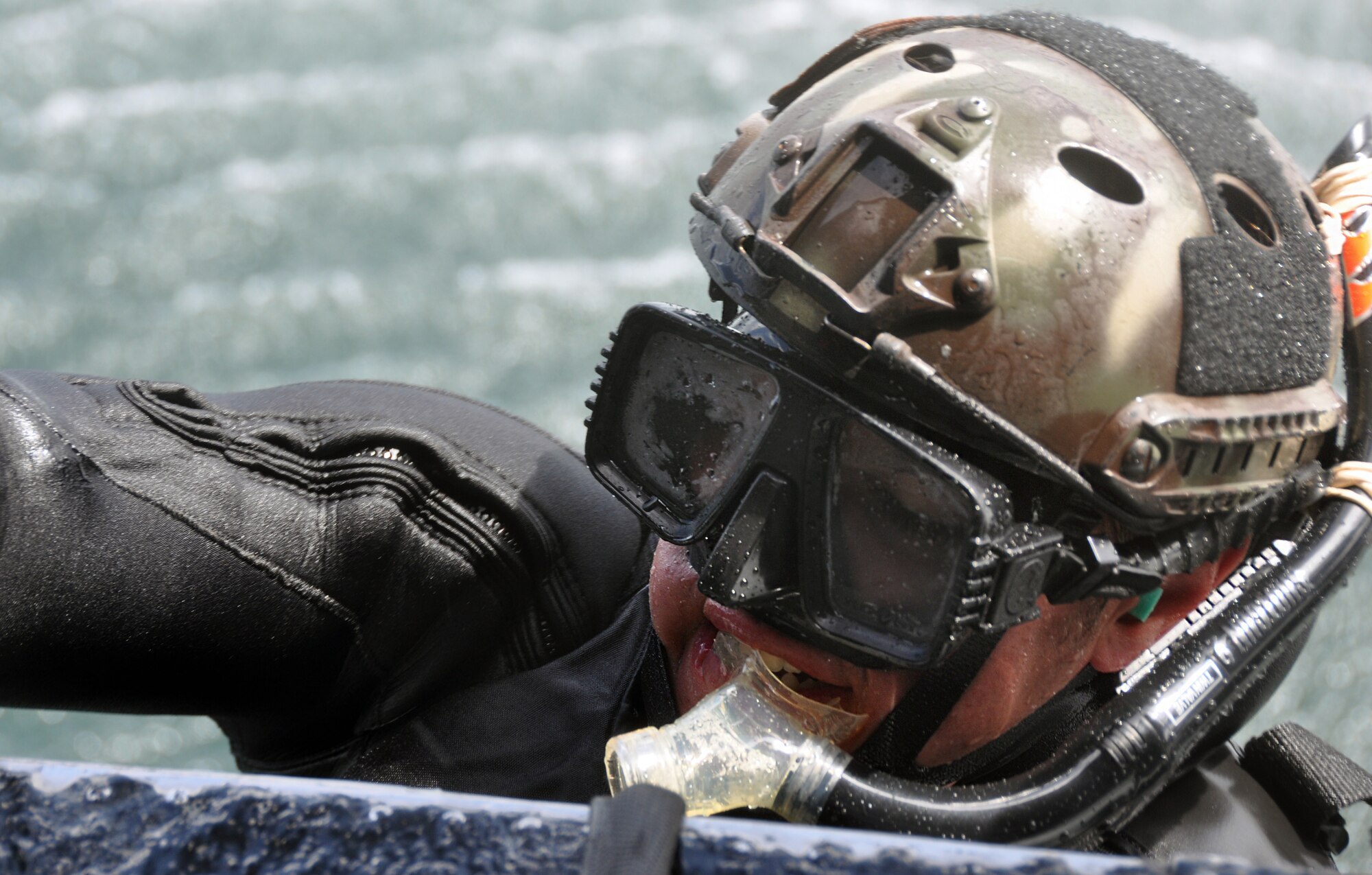 A pararescueman from the 304th Rescue Squadron, Portland Air National Guard Base, Ore., pulls himself into an HH-60 Pave Hawk helicopter from the 305th Rescue Squadron, Davis Monthan Air Force Base, Ariz., over the Pacific Ocean near Oregon’s northern coast May 5, 2015. The pararescuemen practiced various rescue scenarios in the ocean as part of annual training. Both squadrons are geographically separated units of the 920th Rescue Wing, a combat search-and-rescue Air Force Reserve wing located at Patrick AFB, Fla. (U.S. Air Force photo by 2nd Lt. Anna-Marie Wyant)