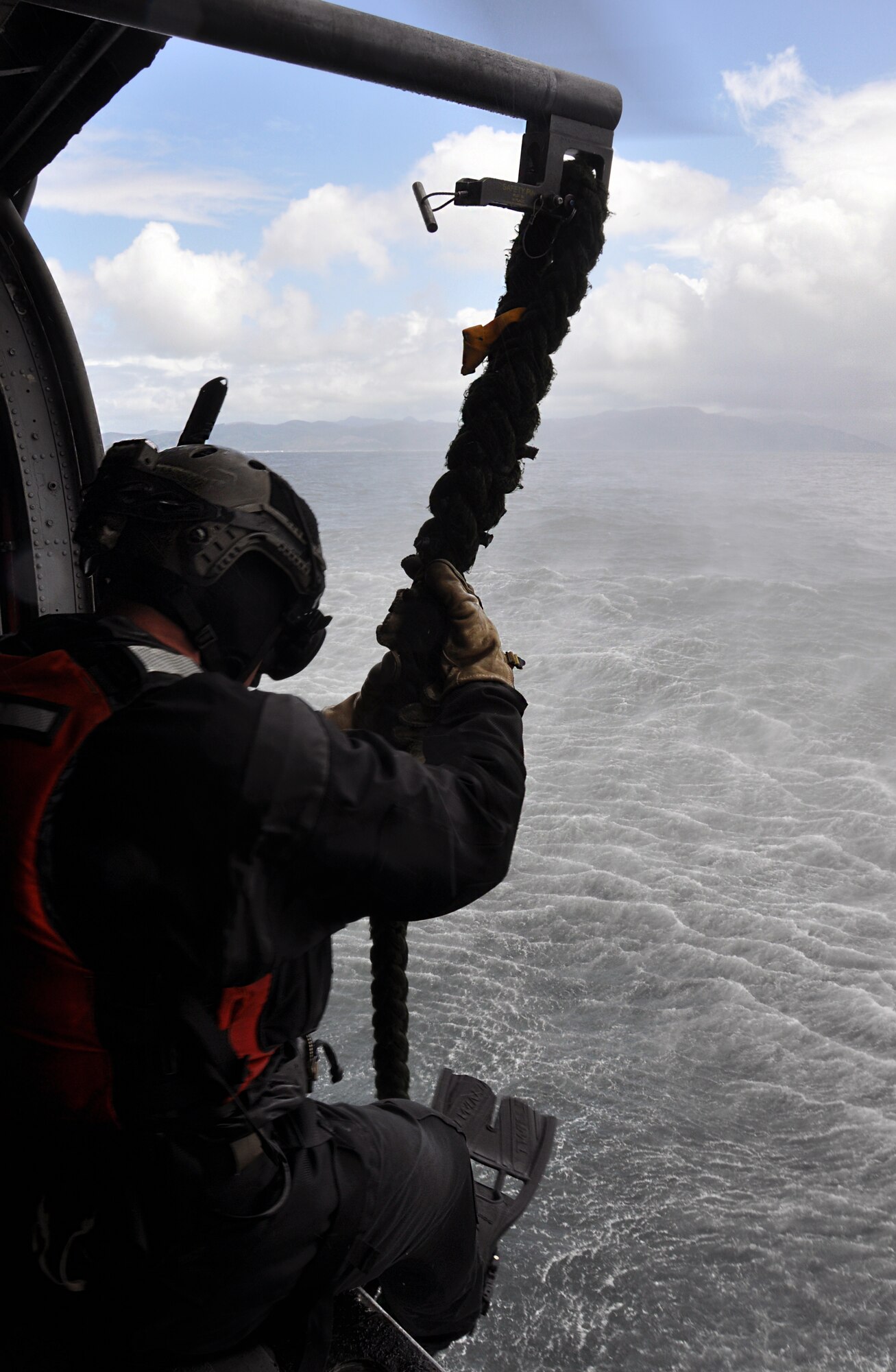A pararescueman from the 304th Rescue Squadron, Portland Air National Guard Base, Ore., prepares to fast-rope from an HH-60 Pave Hawk helicopter into the Pacific Ocean off Oregon's northwestern coast May 5, 2015. The Pave Hawk and crew were from the 305th Rescue Squadron, Davis Monthan Air Force Base, Ariz., and trained with the 304th for a week. Both squadrons are geographically separated units of the 920th Rescue Wing, a combat search-and-rescue Air Force Reserve wing located at Patrick AFB, Fla. (U.S. Air Force photo by 2nd Lt. Anna-Marie Wyant)